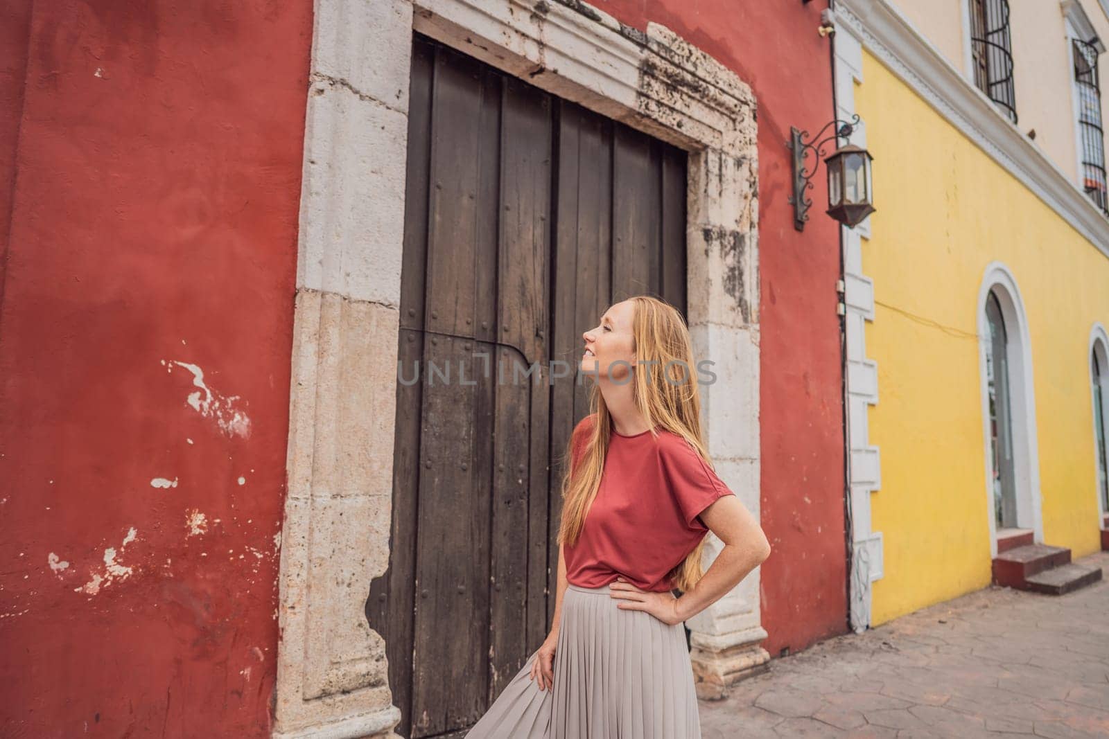 Woman tourist explores the vibrant streets of Valladolid, Mexico, immersing herself in the rich culture and colorful architecture of this charming colonial town by galitskaya