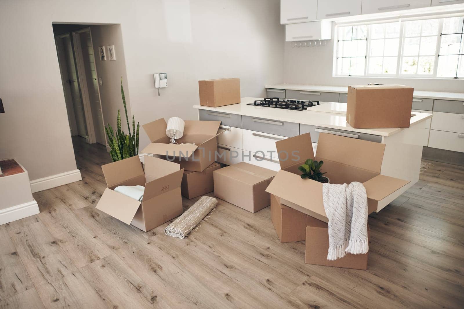 Room, boxes and relocation for moving, apartment and new home with belongings, unpack and no people. Cardboard, mortgage and property for real estate, packaging and kitchen counter in modern house by YuriArcurs