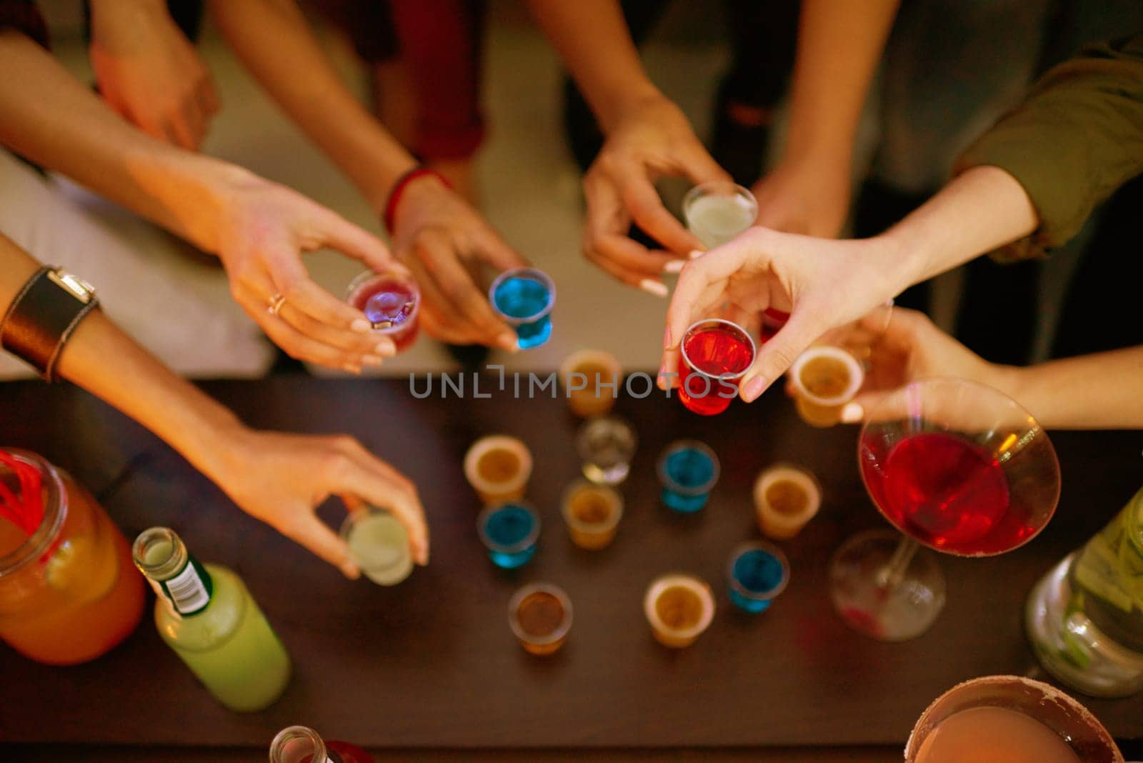 Party, glass and hands of people with alcohol shots at event for toast, celebration or bonding together. Cheers, cocktail beverage and friends group for happy hour, social gathering or entertainment.