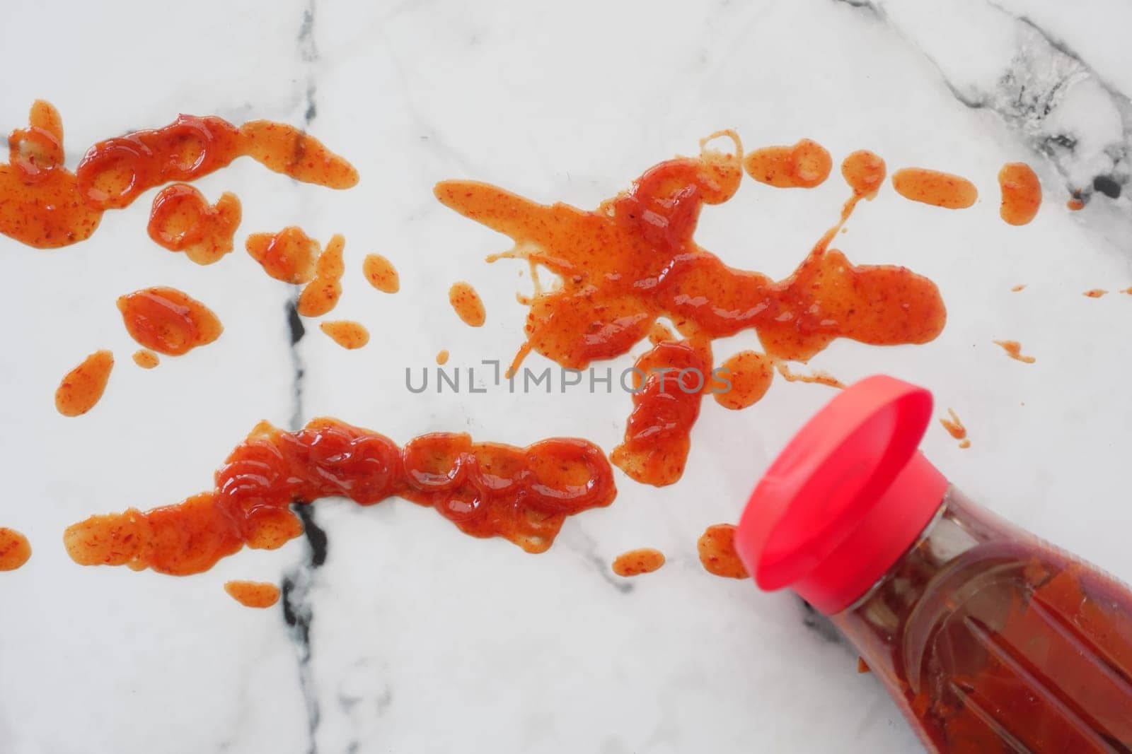 red ketchup splashes on tiles background, tomato puree texture