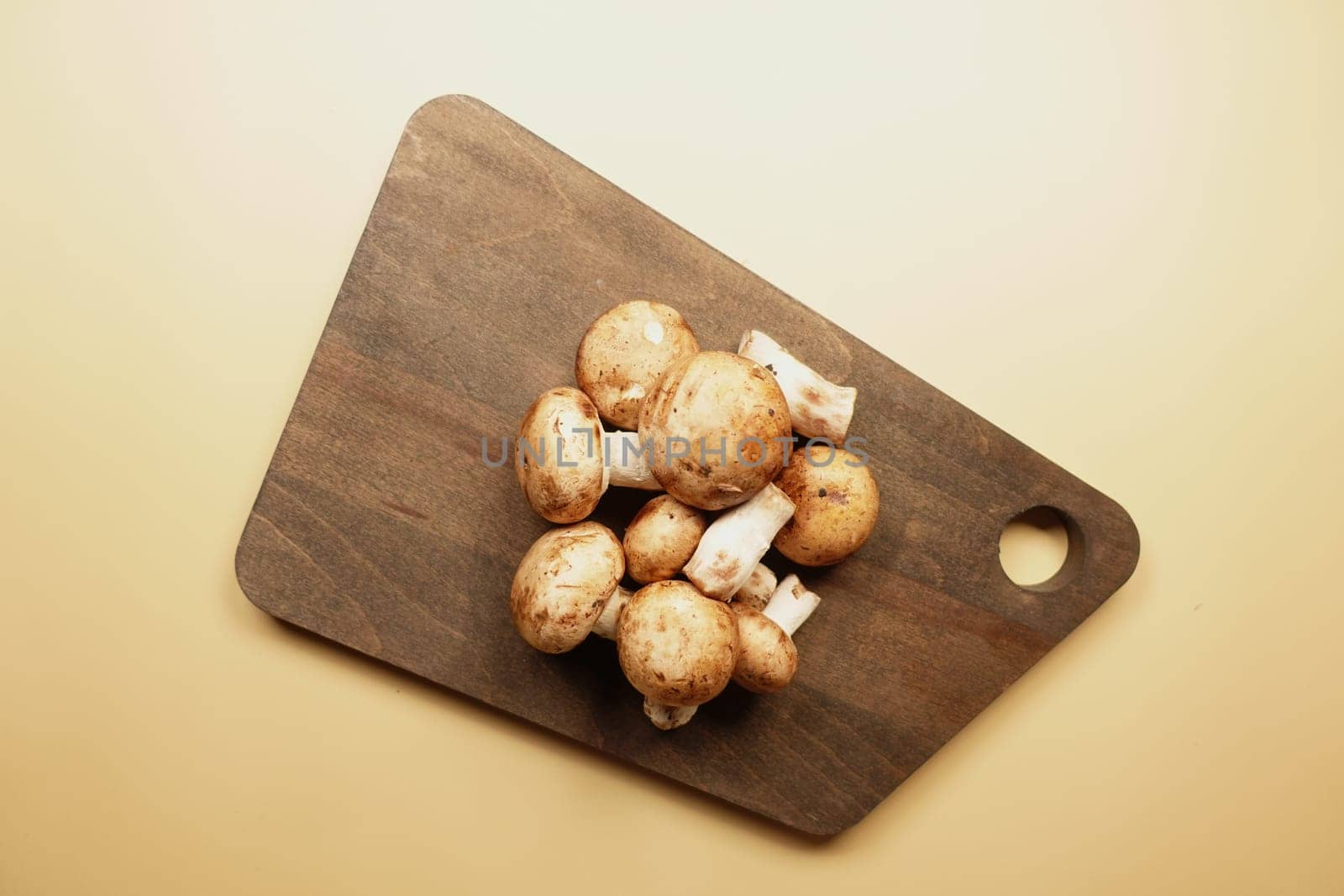 top view of Fresh champignons mushroom on a chopping board by towfiq007