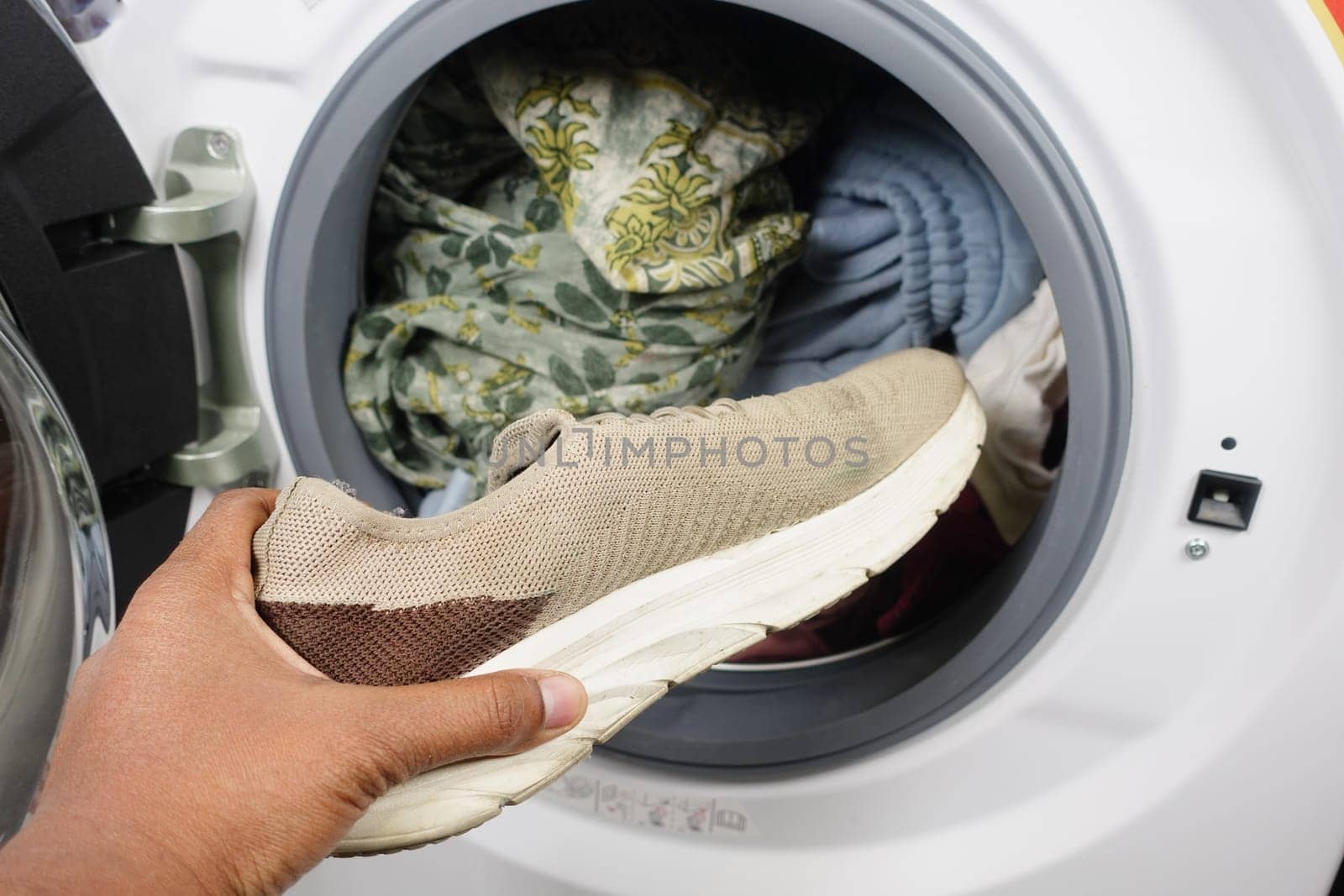 putting dirty shoe in a washing machine. by towfiq007