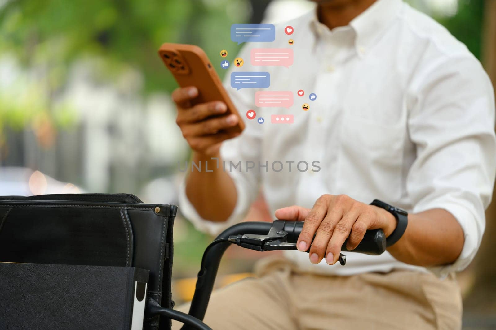Cropped shot male sitting on his bicycle using mobile phone with notification icons.