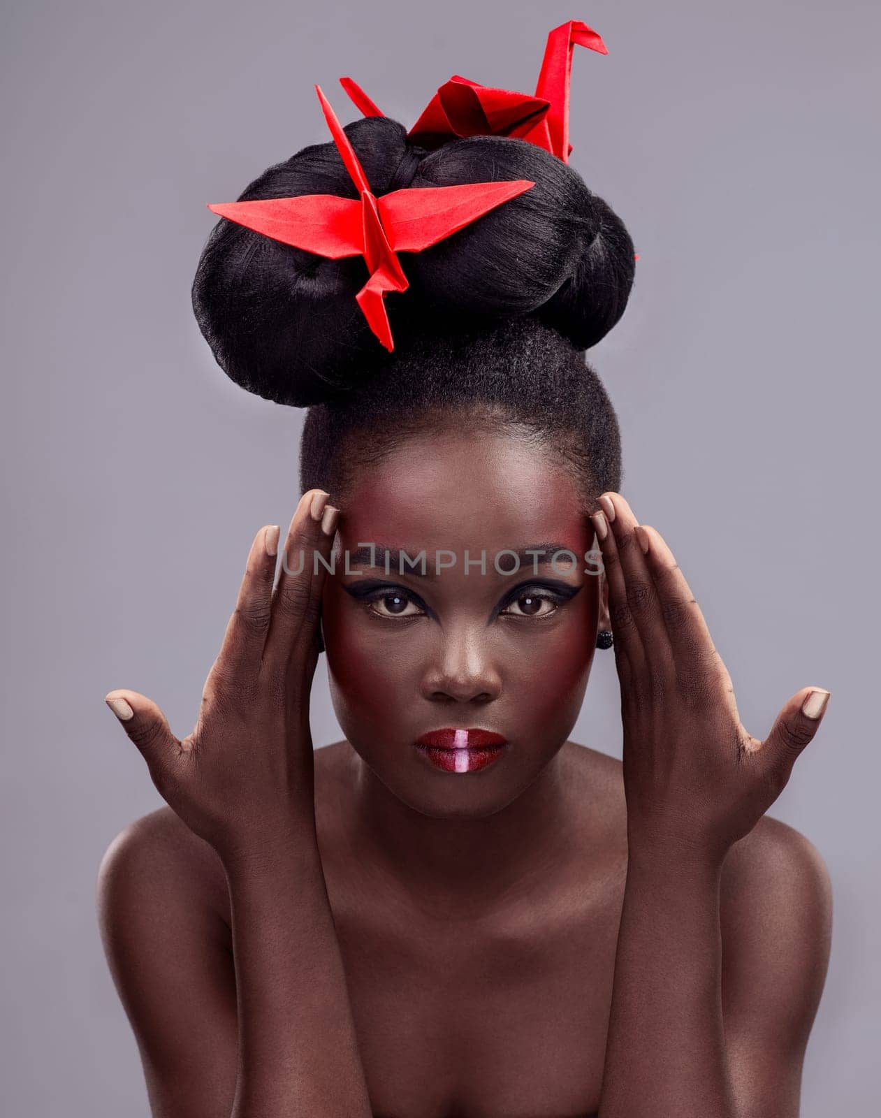 Portrait, black woman and origami bird in studio isolated on gray background with makeup for aesthetic. Cosmetics, symbolism and glow with beauty, skincare and tradition with cultural expression.