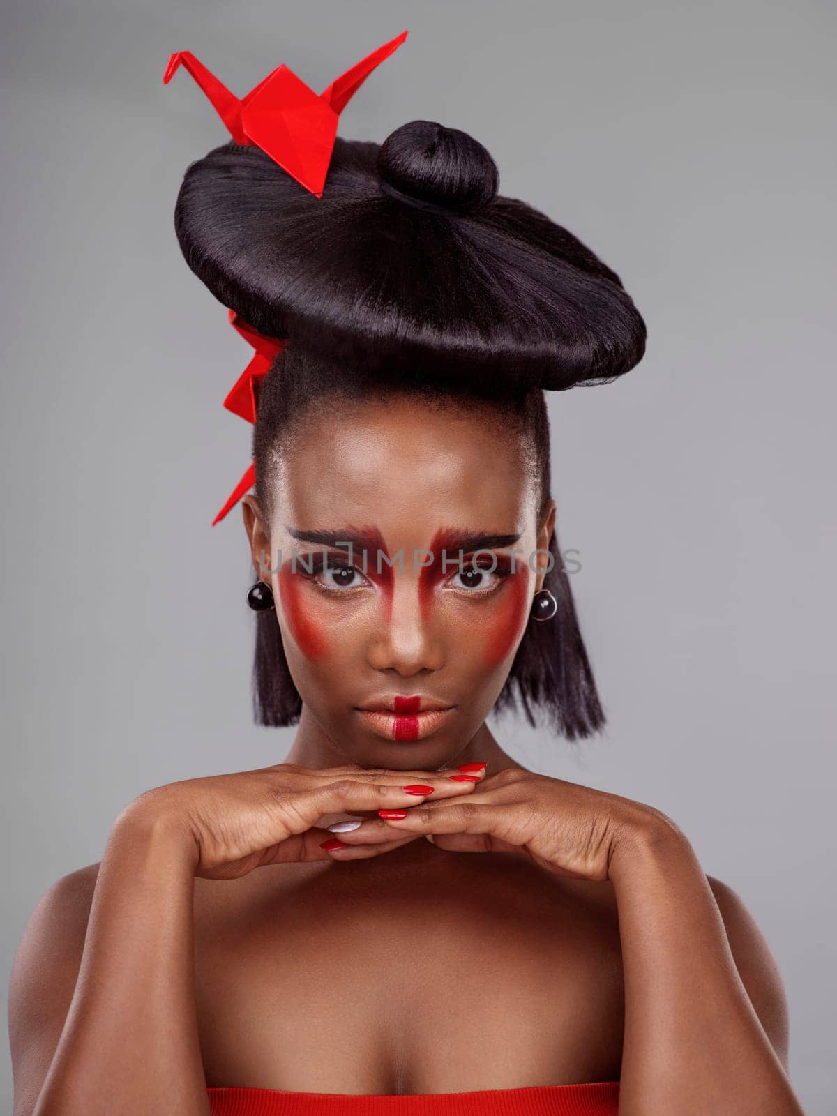 Creative beauty, portrait and black woman with origami in studio isolated on dark background. Serious face, makeup and skincare with African female, traditional and Japanese paper art for cosmetics.