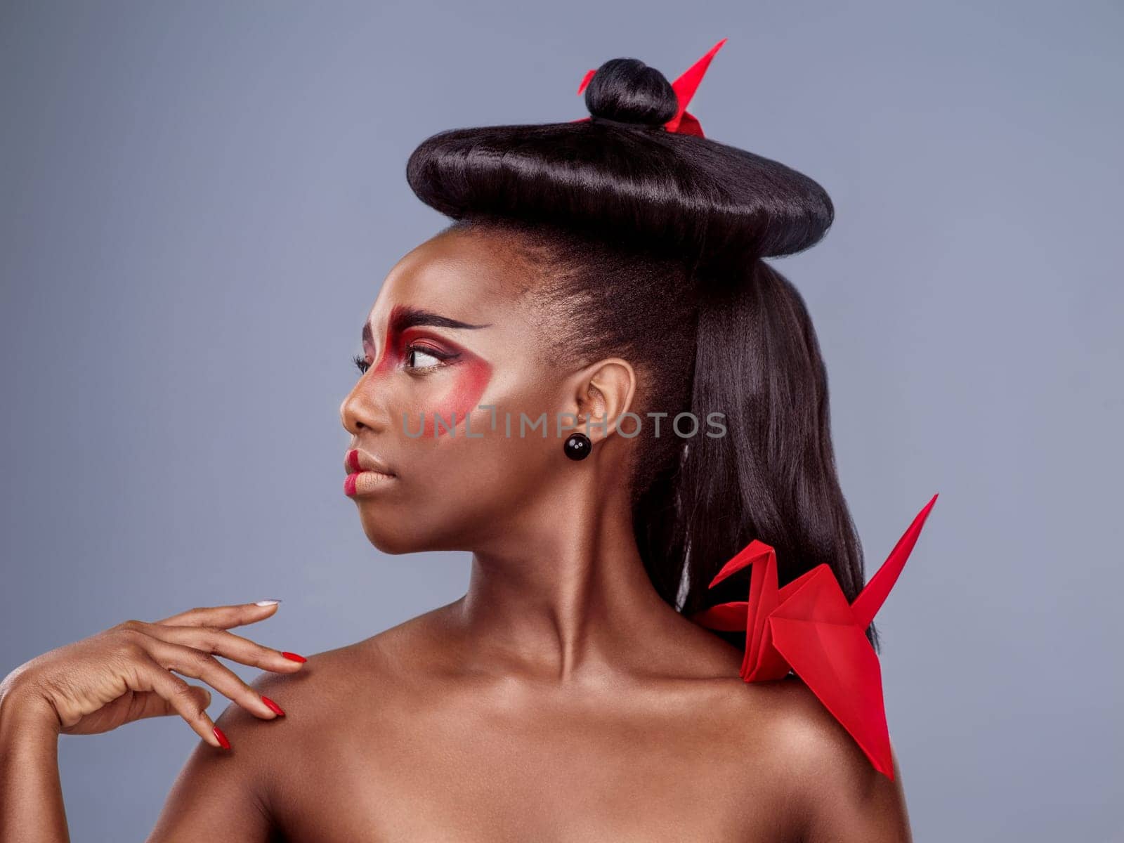 Asian fashion, culture and origami with black woman in studio isolated on gray background for style. Beauty, thinking or tradition with African model in makeup for cosmetics, fusion and inspiration.