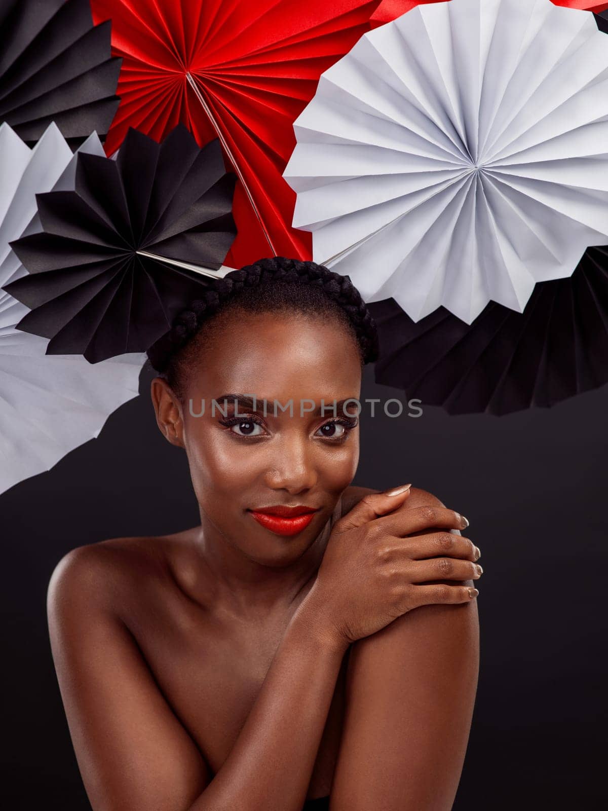Beauty, portrait and black woman with origami fans in studio, smile and dark background. Face, makeup and cosmetics of female model for aesthetic, traditional Japanese and paper art for culture hat by YuriArcurs