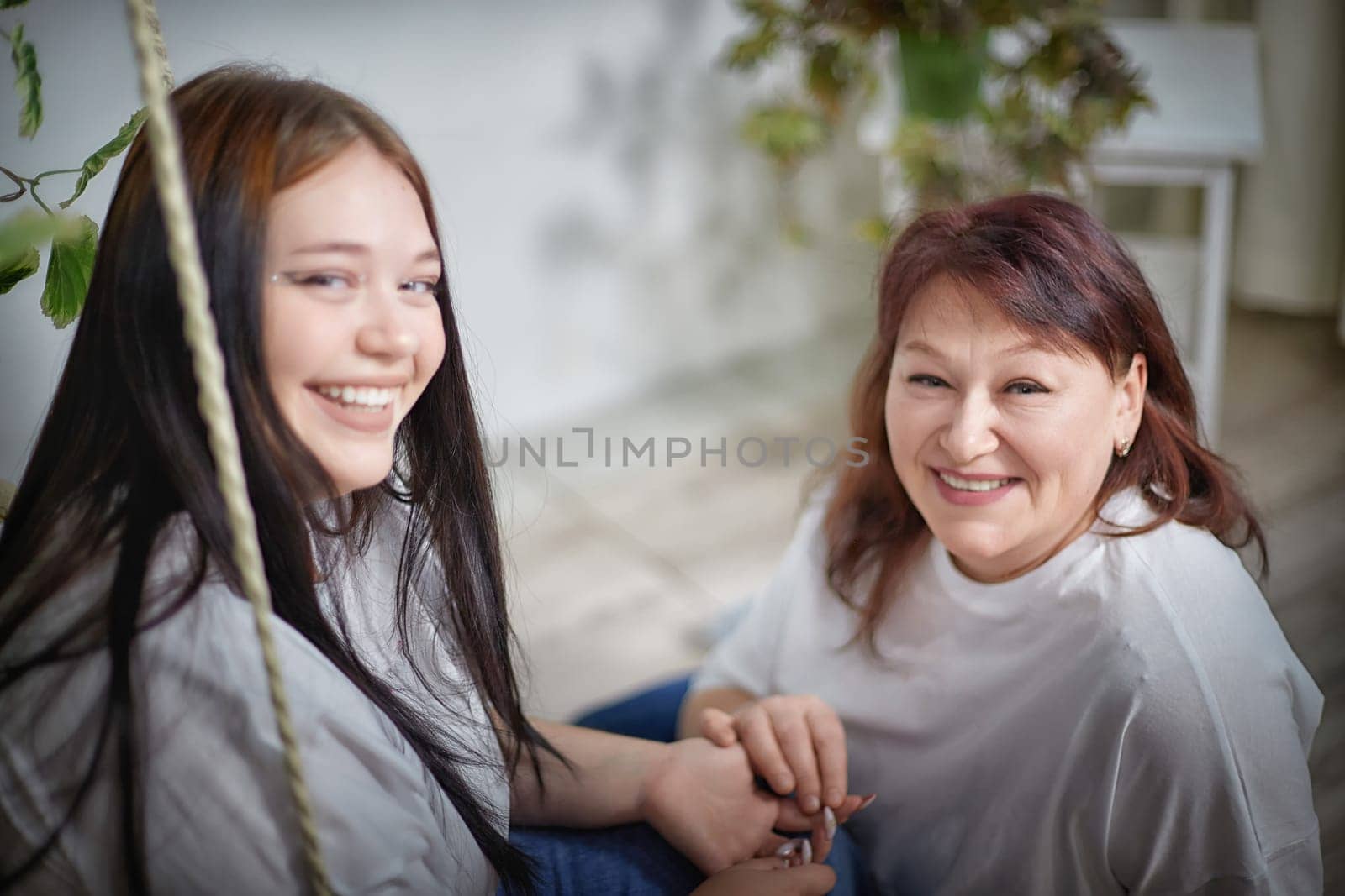 Happy Overweight family with mother and daughter in room. Middle aged woman and teenager girl having fun, joy and hugging