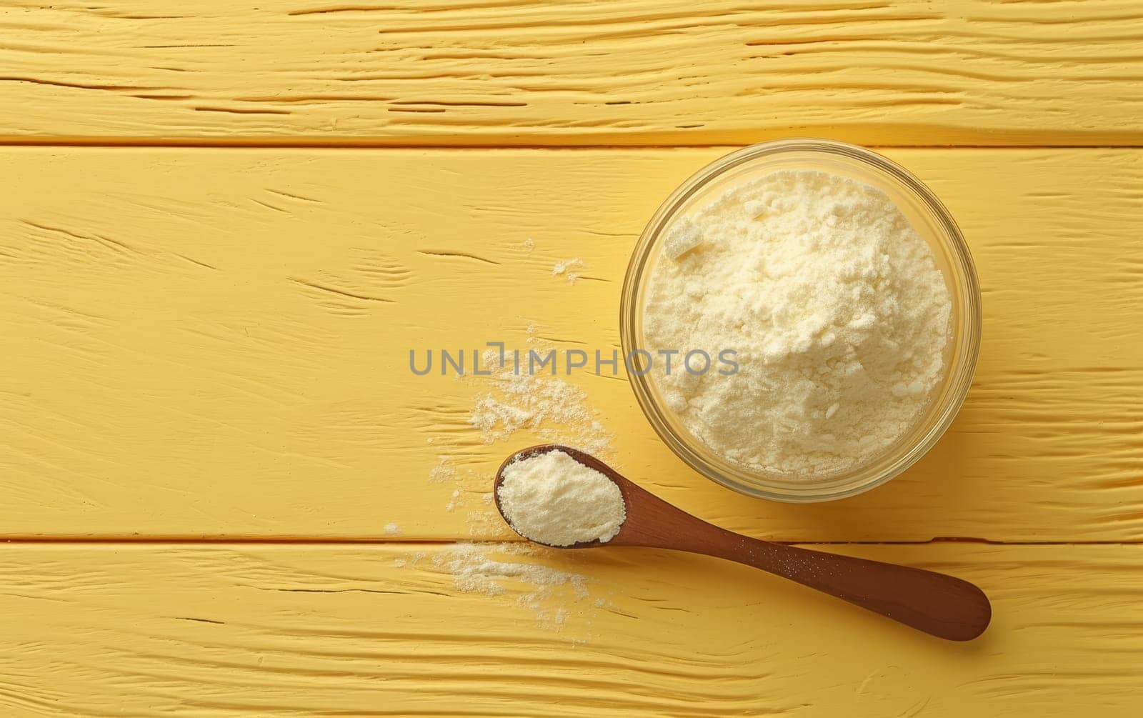 Hydrolyzed collagen powder in a bowl and a spoon on a wooden yellow background with copy space