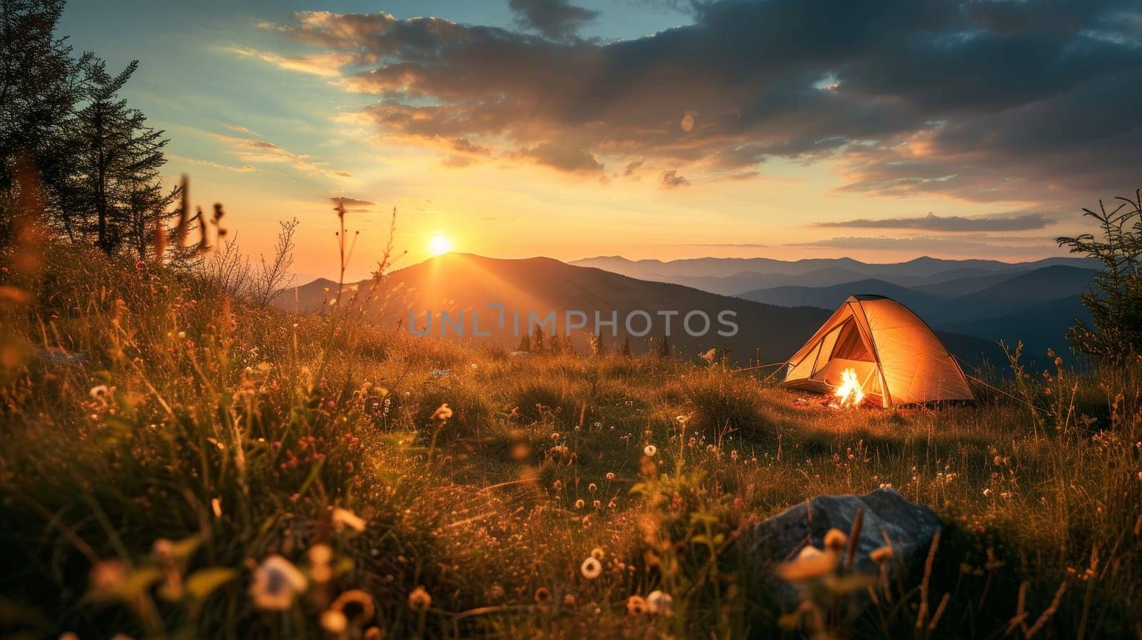 Tent illuminated from within beside a campfire in a serene forest setting during sunset with mountain backdrop