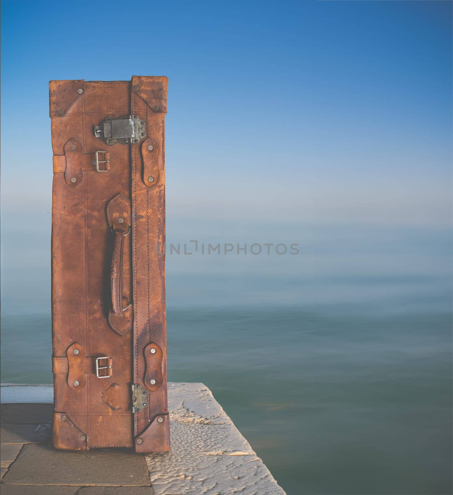 Conceptual Image Of A Vintage Suitcase By The Edge Of An Ocean, With Copy Space