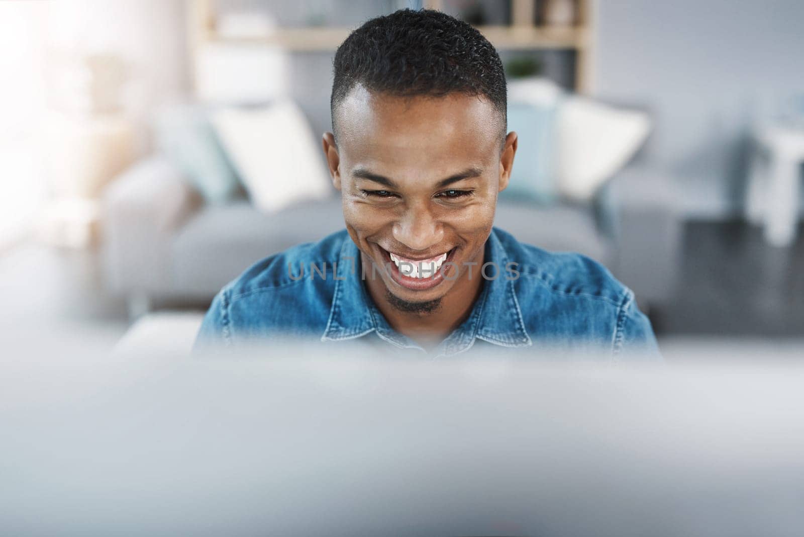 Confidence, smile and black man by computer in office, workspace and desk happy in creative career. Happiness, internship and journalist with technology for typing, research and internet for working by YuriArcurs