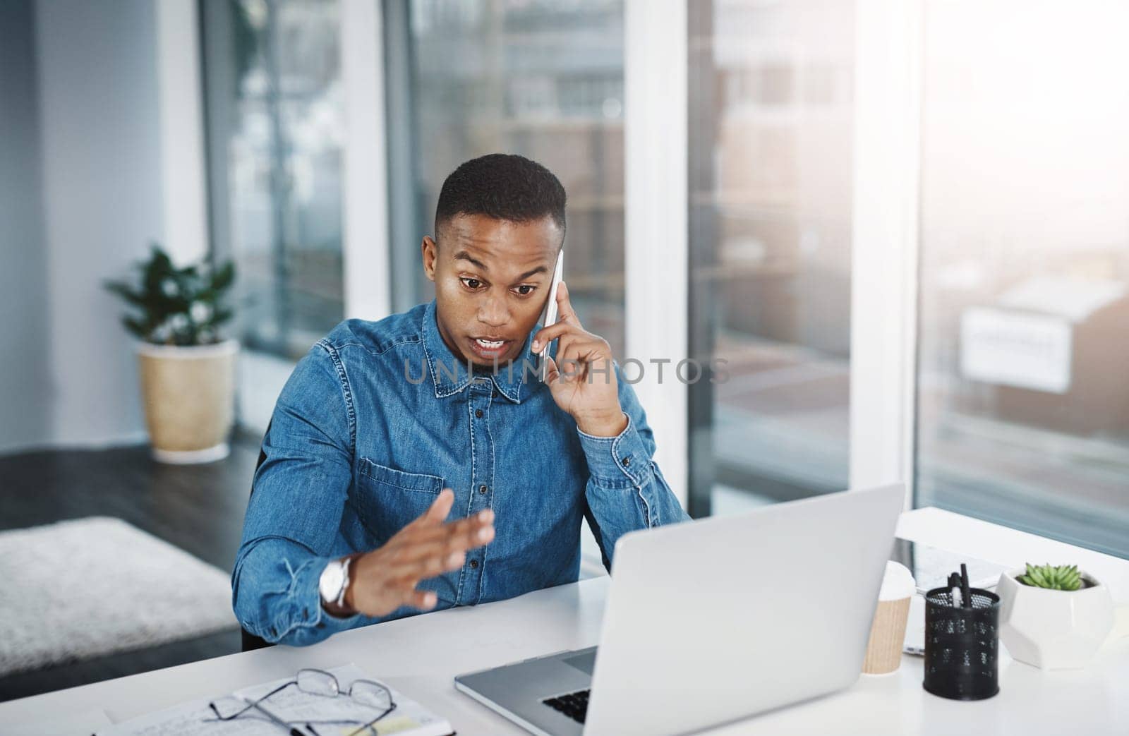 Discussion, phone call and black man by computer in office, workspace and desk happy in creative career. Communication, internship and journalist with tech for contact, research and internet.