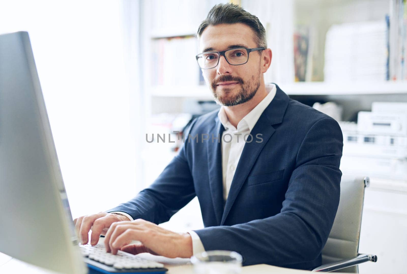 Businessman, smile and working in portrait on computer, email or planning a project in home office. Mature worker, sitting and writing a review or search on technology, typing for report or proposal by YuriArcurs