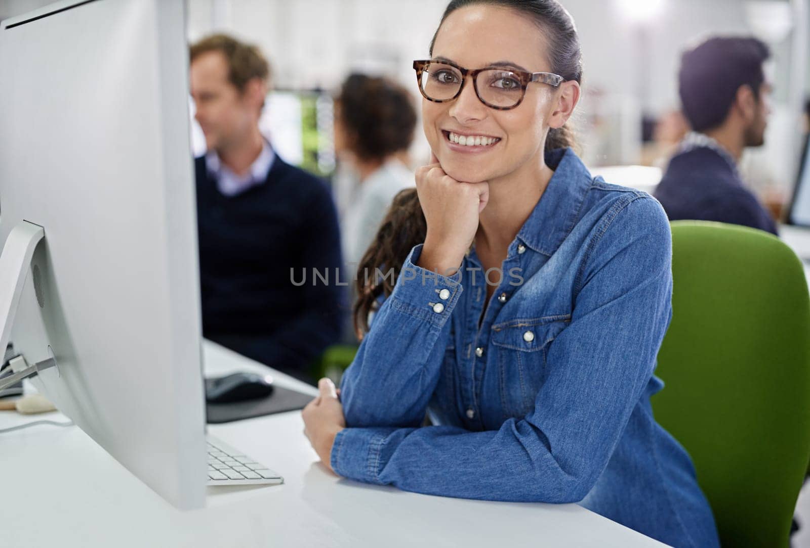 Portrait, woman and employee with computer, smile and office as workplace for company, startup or business. Female person, happy and technology for IT in web development as designer for employer by YuriArcurs