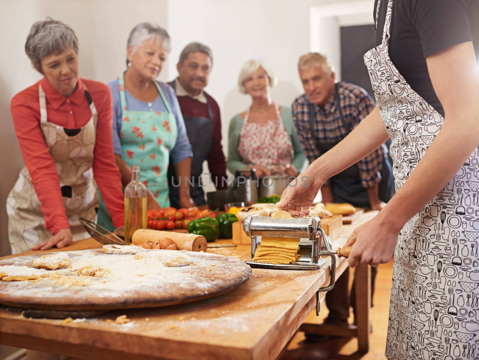 Cooking course, pasta and chef with senior people in kitchen for help, guide or how to questions, advice or steps. Learning, class and nutritionist with audience for teaching, ravioli or nutrition.