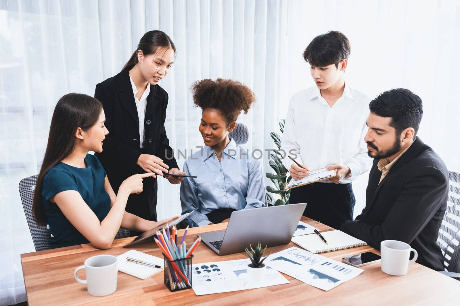 Multiracial analyst team use BI Fintech software to analyze financial data on meeting table. Financial dashboard data display on laptop screen with analyzed chart for marketing indication. Concord