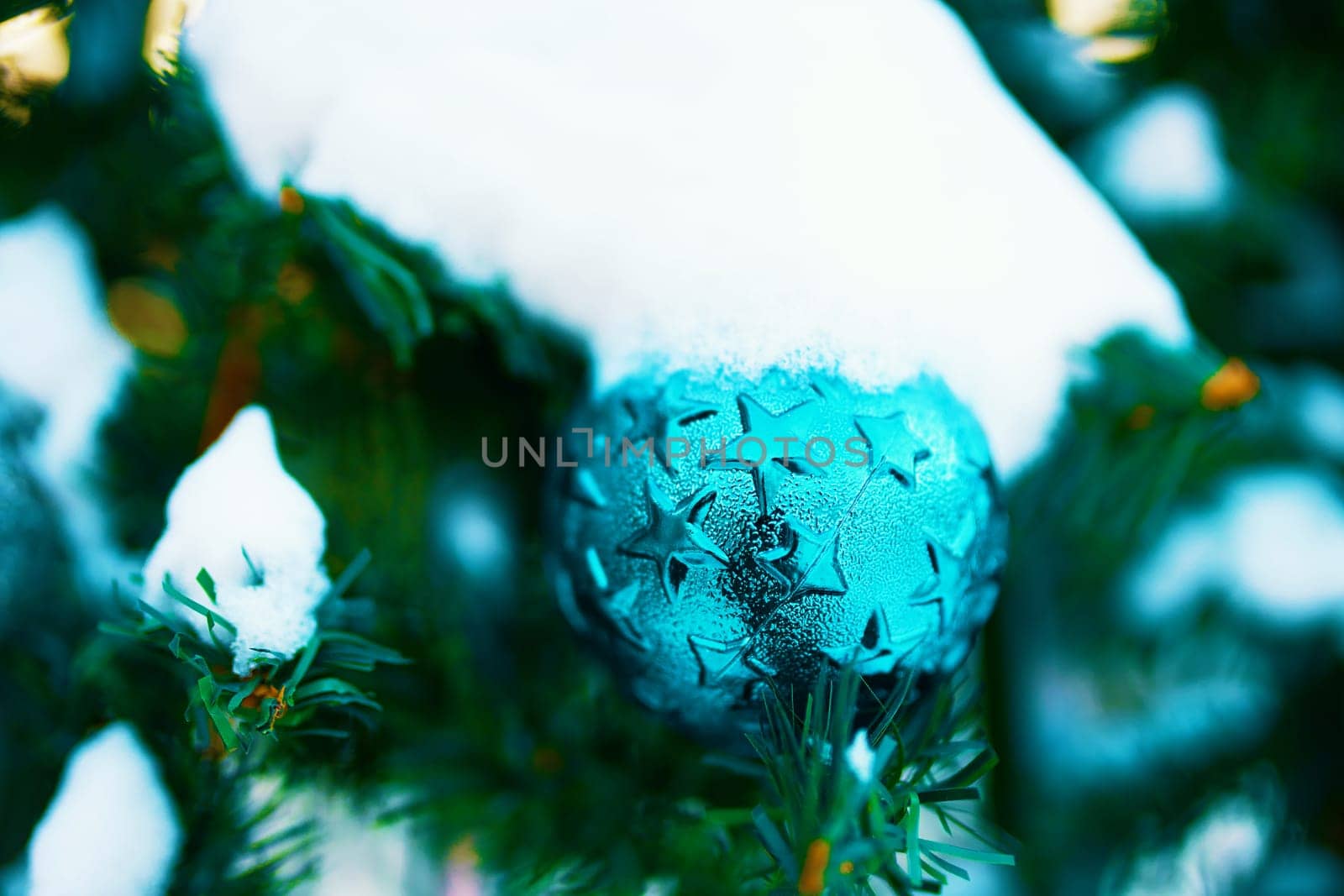 Decorated Christmas tree. Close-up of a blue bubble hanging from a decorated Christmas tree.