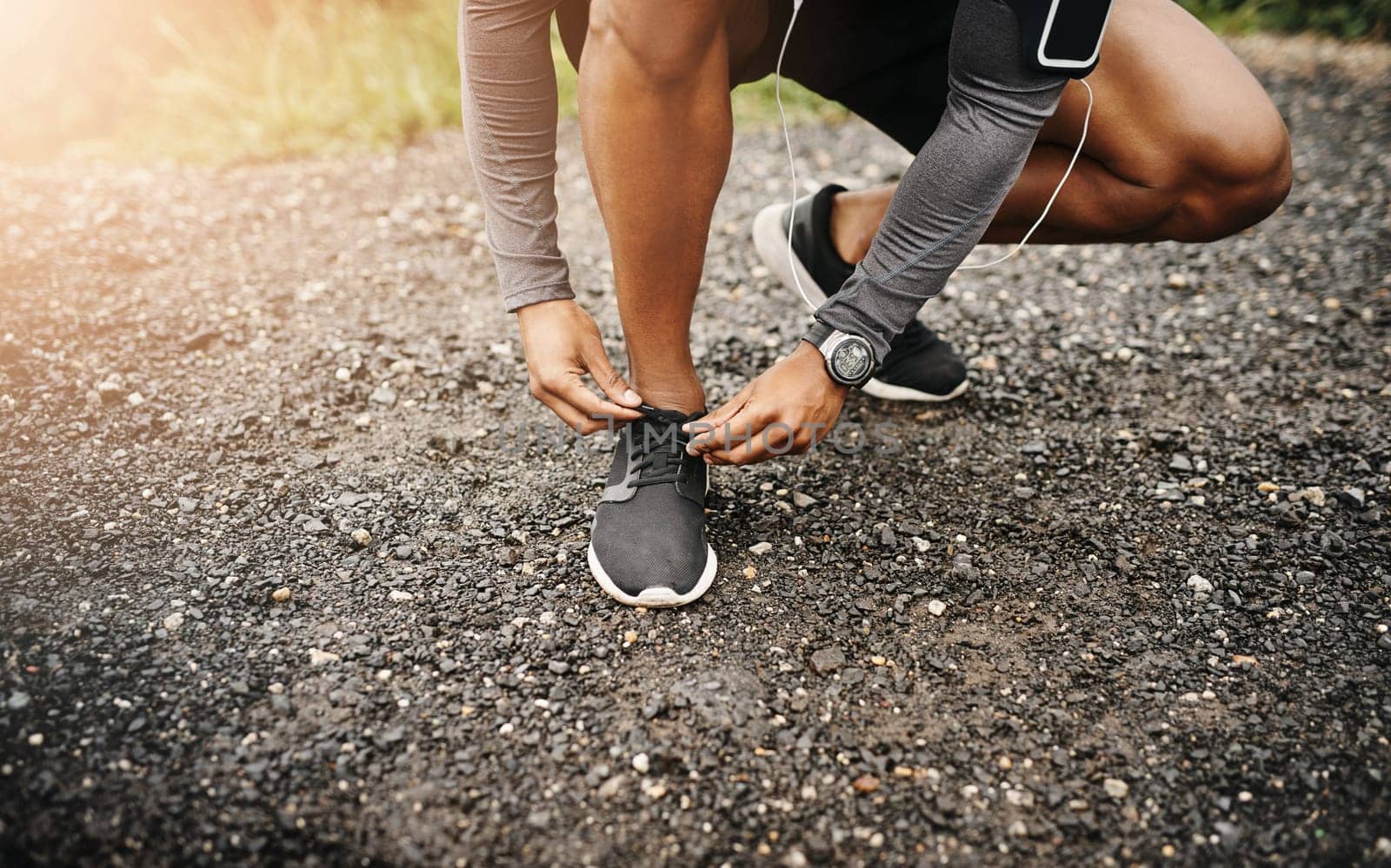 Person, hands and shoelace with exercise or running for fitness, health and wellbeing in outdoor. Road, sneakers and committed on workout or jog in morning for training, wellness and self care.