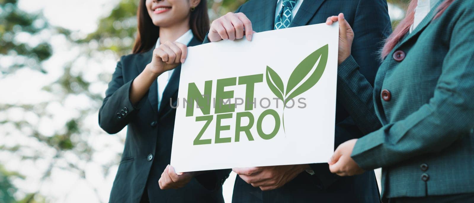 Group of business people stand united, holding eco-friendly idea and concept for environmental awareness campaign by business corporate to embrace net zero emission and environmental friendly. Gyre