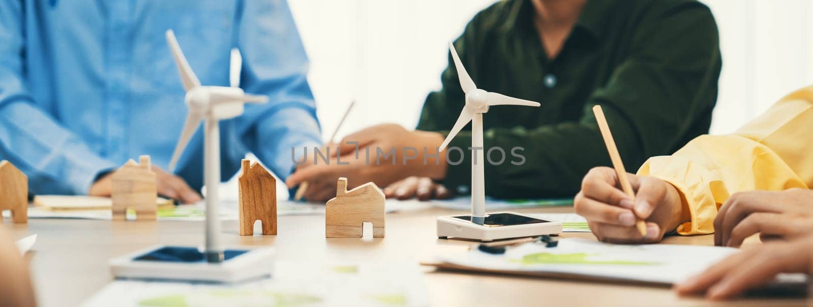 Green business meeting represented renewable energy. Skilled businesspeople discuss green business investment at table with environmental documents. Closeup. Focus on hand. Delineation.