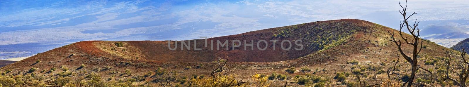 Hill, banner and landscape of mountain in countryside with crater on volcano in Hawaii. Nature, horizon and travel to bush in valley environment in summer with grass, plants and clouds in blue sky.