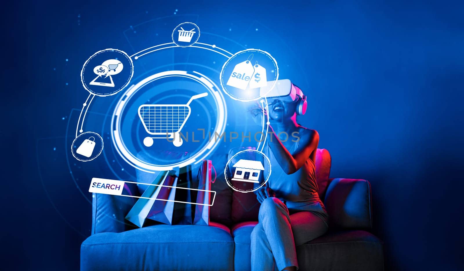 Smart female sitting on sofa while wearing VR headset connecting metaverse, future cyberspace community technology. Elegant woman enjoy open interface online store menu shop product. Hallucination.