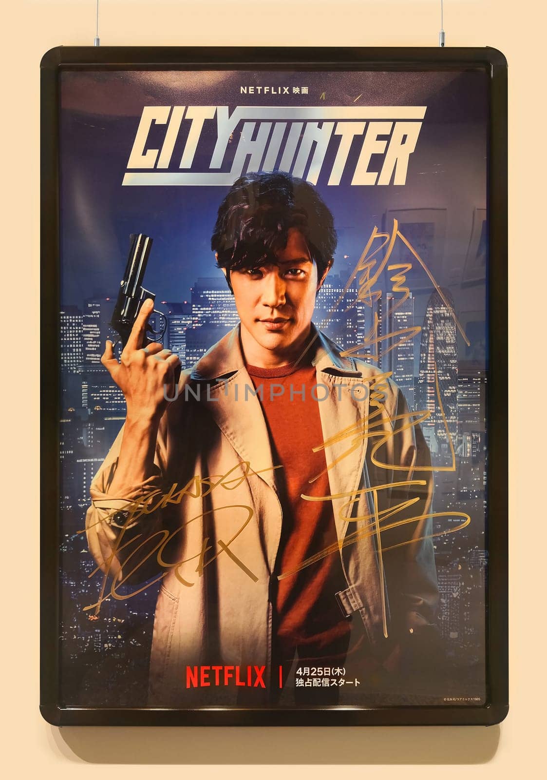 tokyo, japan - apr 25 2024: Netflix action movie poster of City Hunter or Nicky Larson depicting the actor Ryohei Suzuki holding a gun and signed by himself on right and by Tsukasa Hojo on left.