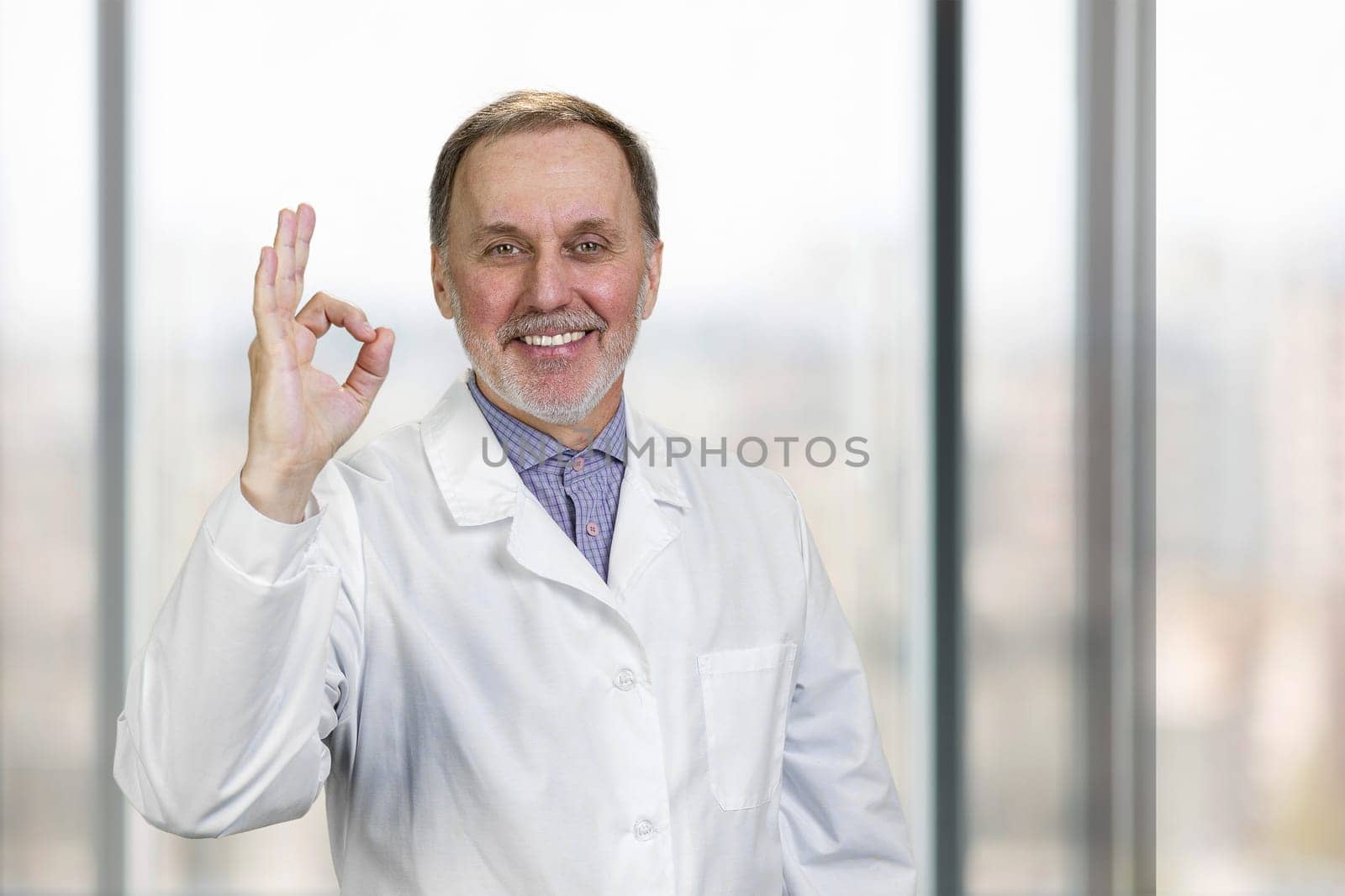 Cheerful senior doctor shows okay gesture sign. by super_picture