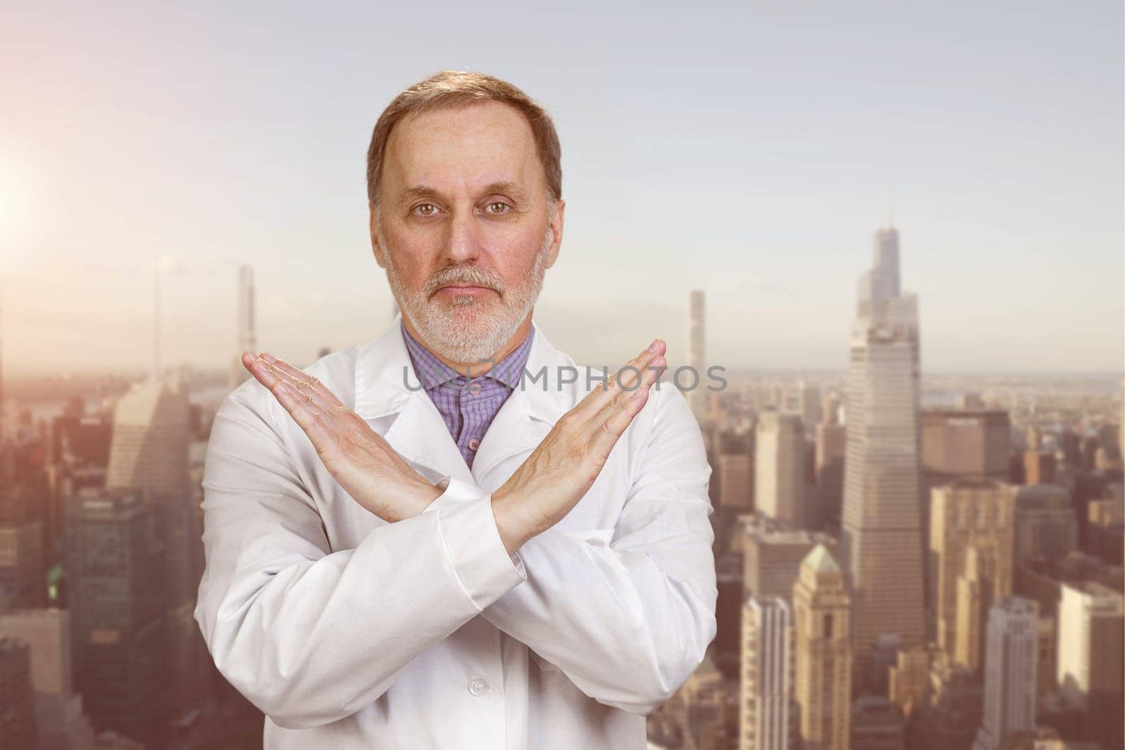 Happy senior medic doctor in white coat shows no reject sign. by super_picture