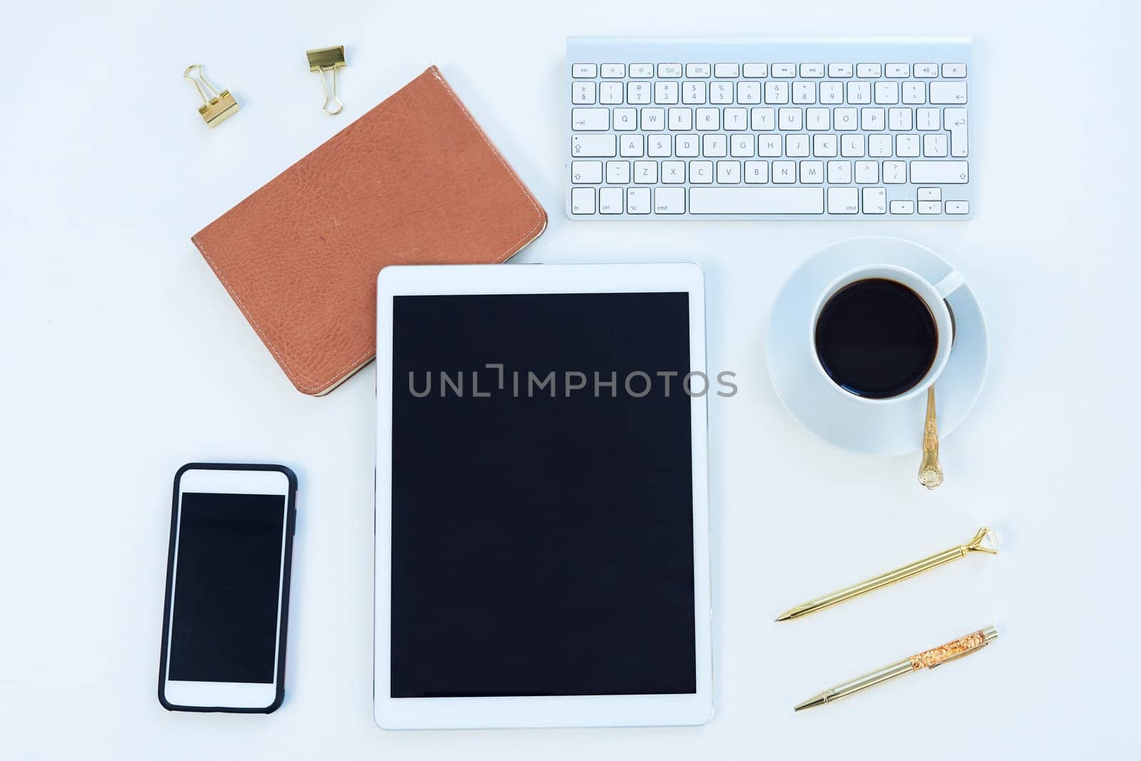 Tablet, phone and blank screen above for social media, tech and business for content creation work. Desk, creative and workspace with startup with ux technology and coffee in a seo app office by YuriArcurs