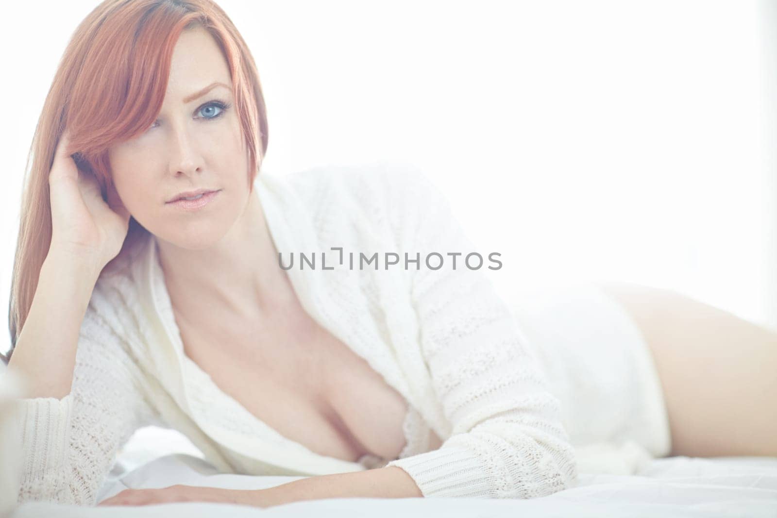 Sexy, woman and relax on bed with portrait in bedroom to rest on holiday or vacation for peace and calm. Girl, lingerie and jersey for aesthetic loungewear with flirty look, alluring and sensuality. by YuriArcurs