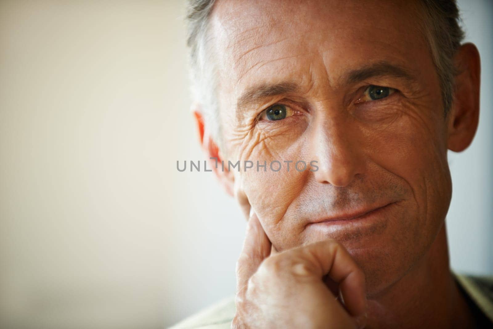 Headshot, senior man and portrait thinking about retirement at home, apartment and living room with mockup space. Hand, idea and mature male person in house to relax in lounge for elderly care.