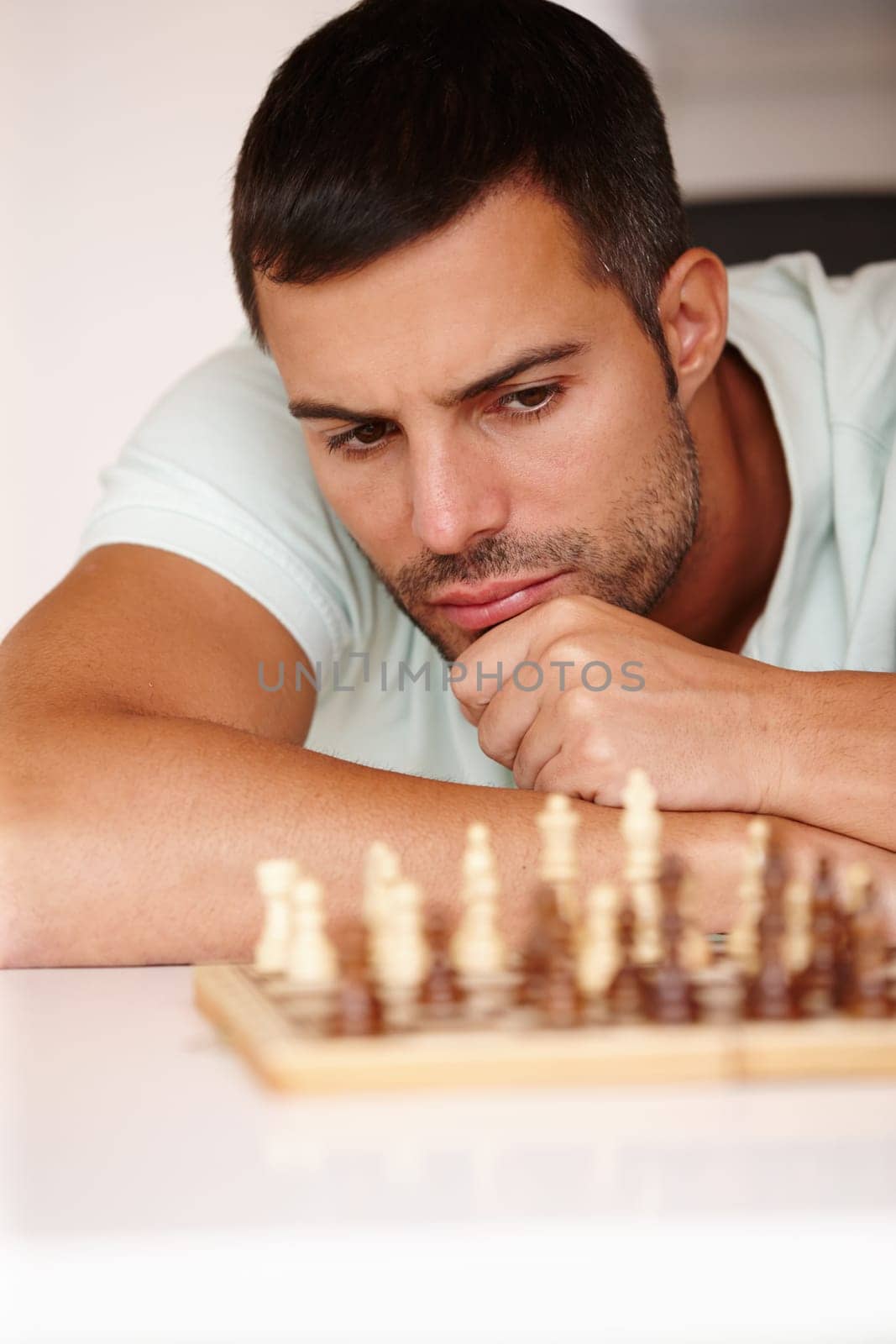 Chess, man and concentration for strategy, thinking and problem solving for games. Face, planning and choice for play on board, hobby and challenge for mind and player to move piece on boardgames by YuriArcurs