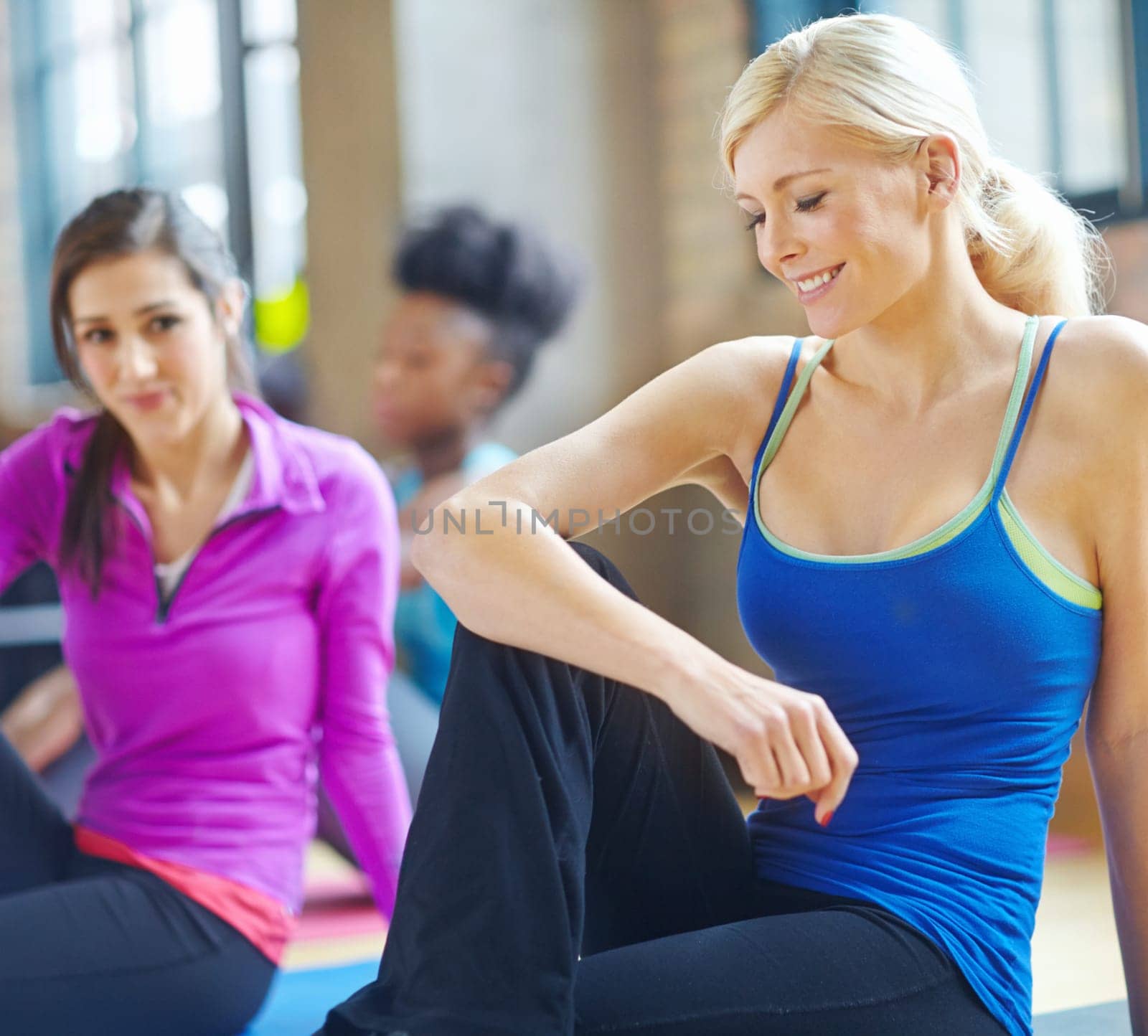Stretching, fitness and woman in pilates health class for training, exercise and warm up on floor. Smile, muscles and female person getting ready for flexibility workout, yoga or wellness.