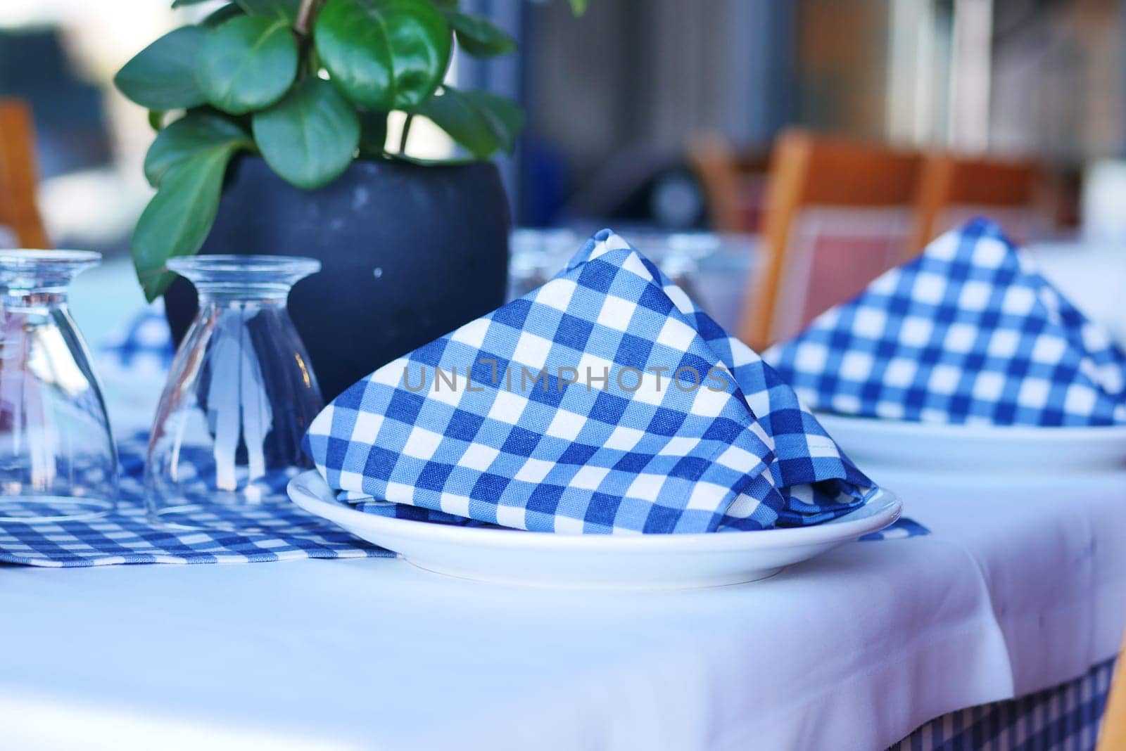 served and decorated round festive table in a restaurant .