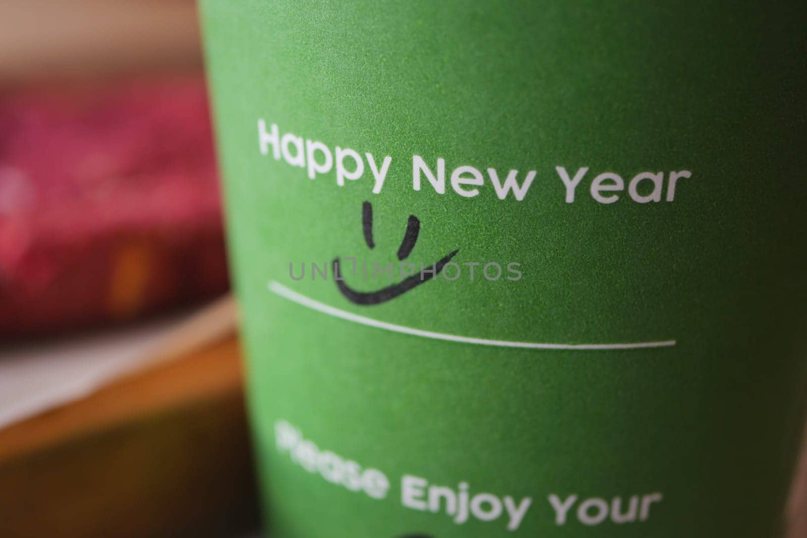 take away kraft coffee cup with happy new year wish on it,