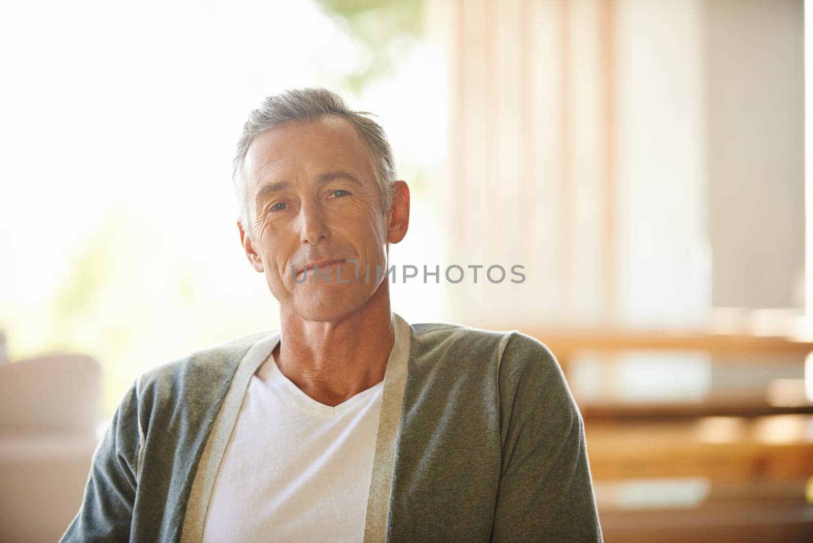 Senior, man and portrait and happy in home, peace and retired or smile for retirement and relax in apartment. Face, gratitude and wellness in living room, comfort or wisdom reflection or elderly care.