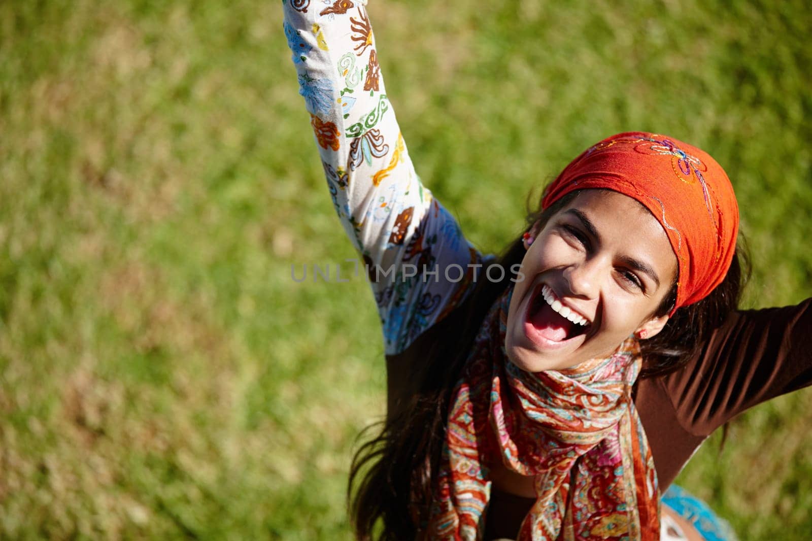 Woman, excited and portrait for outdoor with freedom in nature for summer, outdoor and adventure on grass. Young person, laugh and bohemian style with win for happiness, joy and above in garden by YuriArcurs