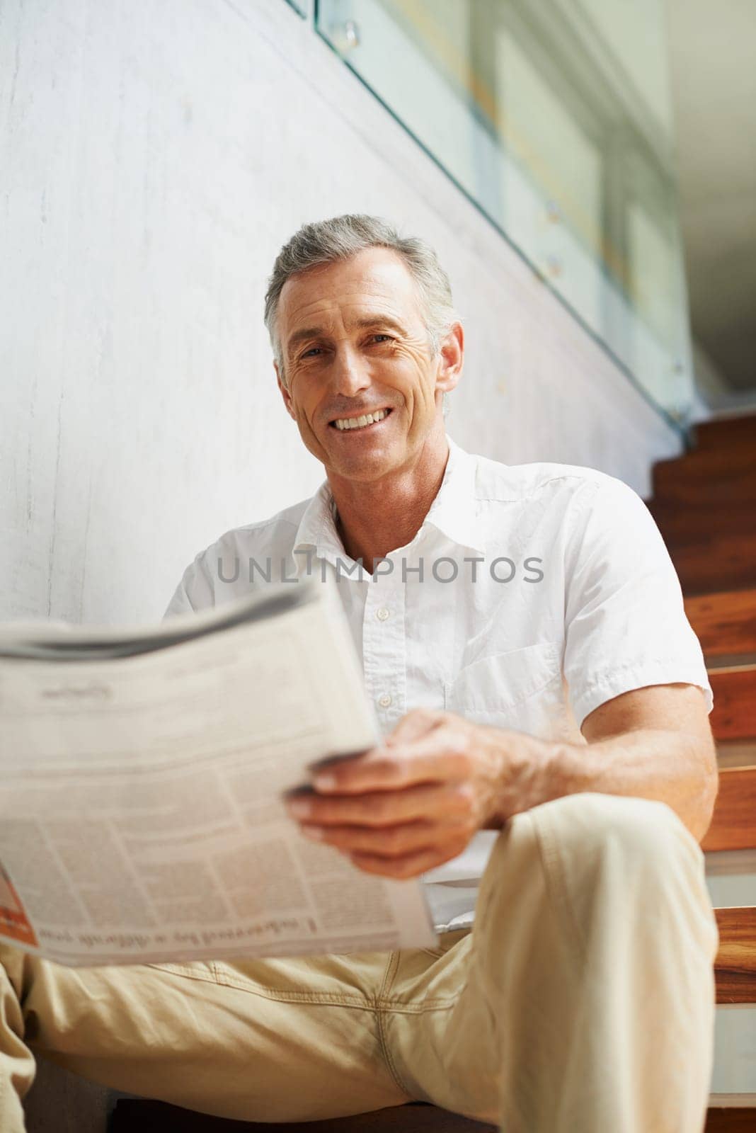 Mature, man and portrait with newspaper in office for stock market review for global news, journalist or investment. Male person, face and business section on stairs for financial, report or press.