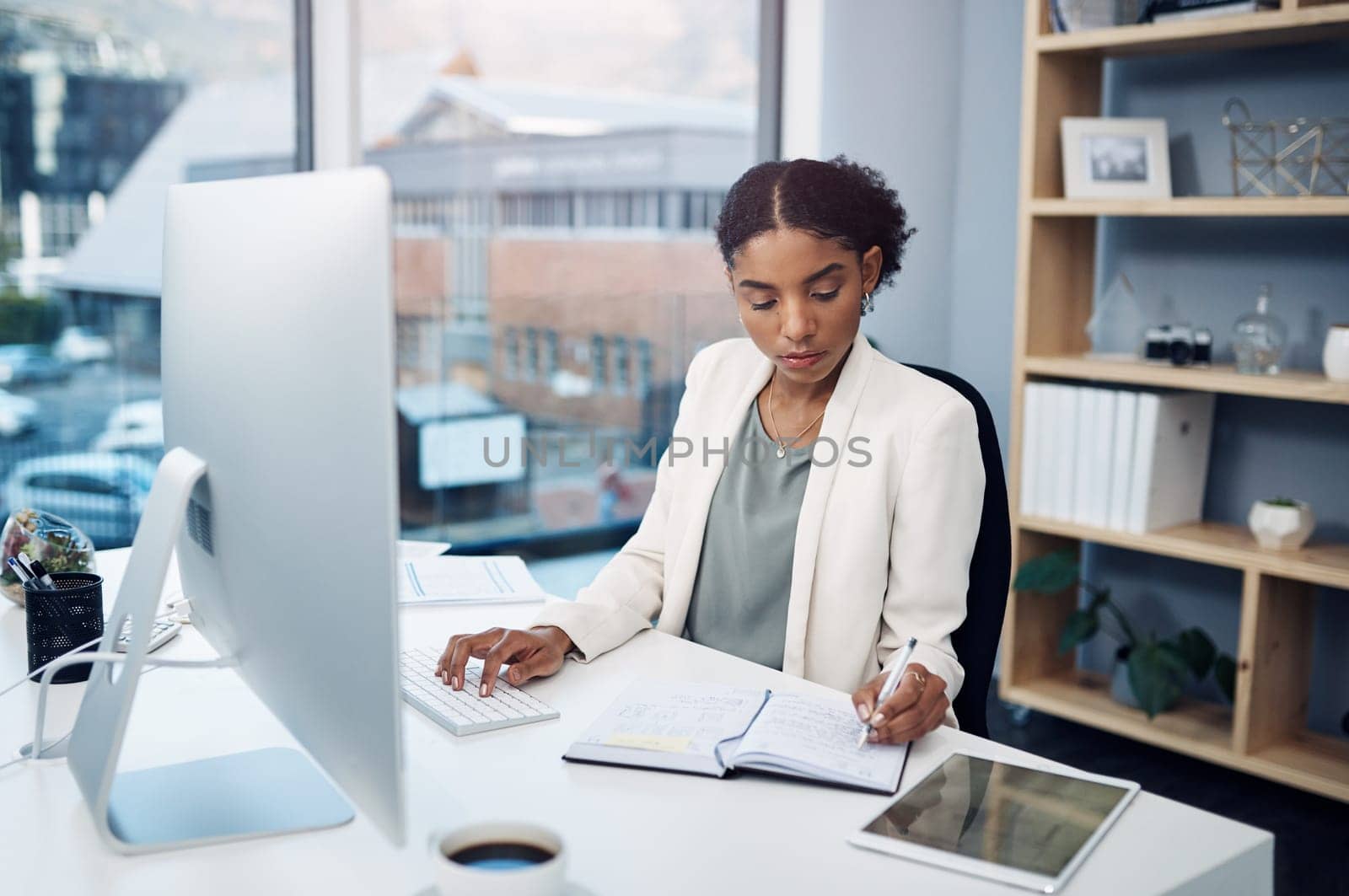 Office, research and woman at computer for notes, business schedule or online profit report at agency. Budget, planning and consultant at desk with notebook, writing and financial risk management.