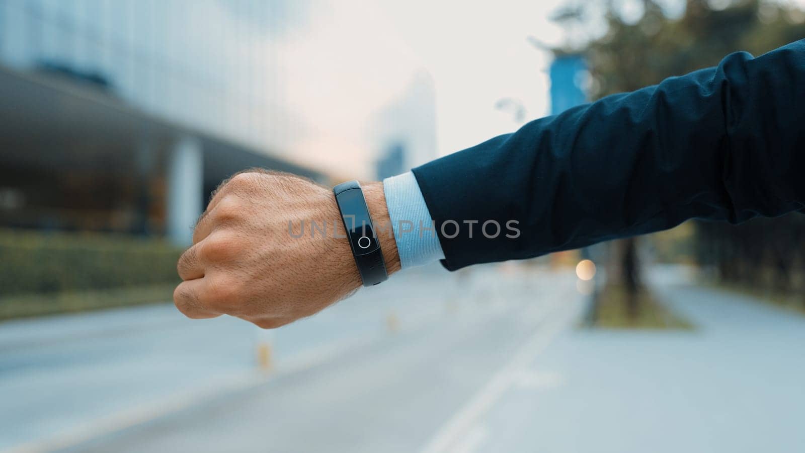 Closeup of professional businessman hand show smart watch and pointing the times. Professional boss, ceo, leader checking time from top view with city view. Business. Blurred background. Exultant.