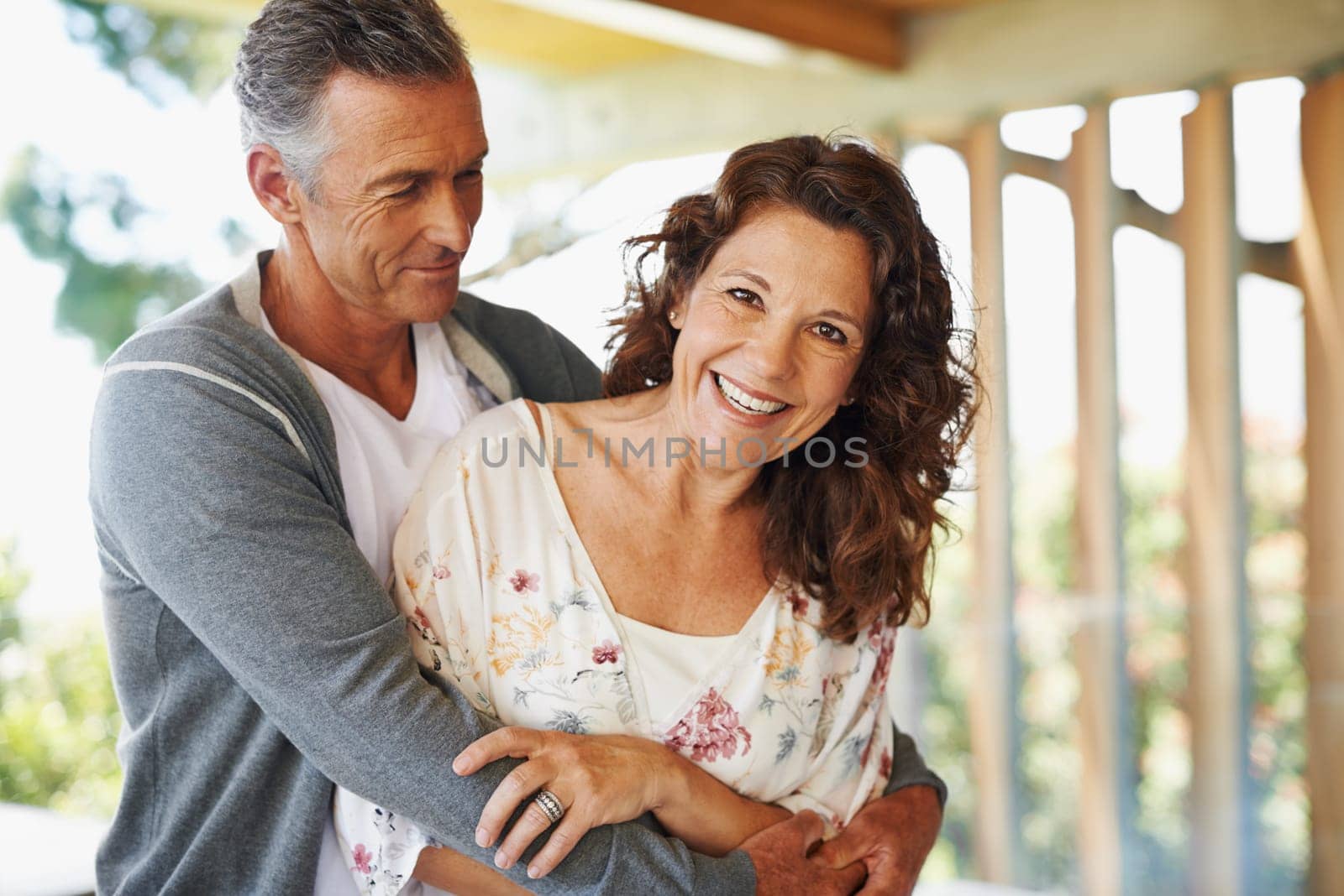 Portrait, smile and couple hug together for love, connection or trust at backyard for partnership. Face, happy woman and embrace mature man with care, commitment and healthy relationship for support.