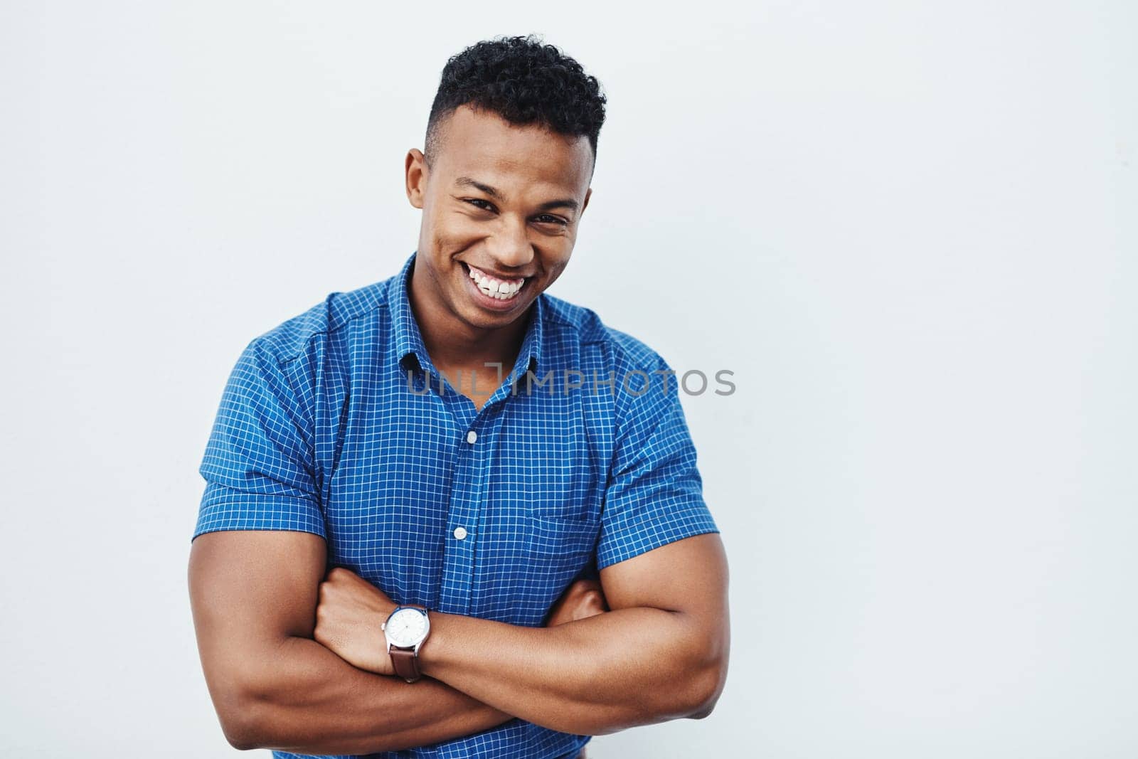 Portrait, business and man with arms crossed, funny and confident guy on white studio background. African person, model or agent with professional, creativity and pride for startup, humor or laughing by YuriArcurs