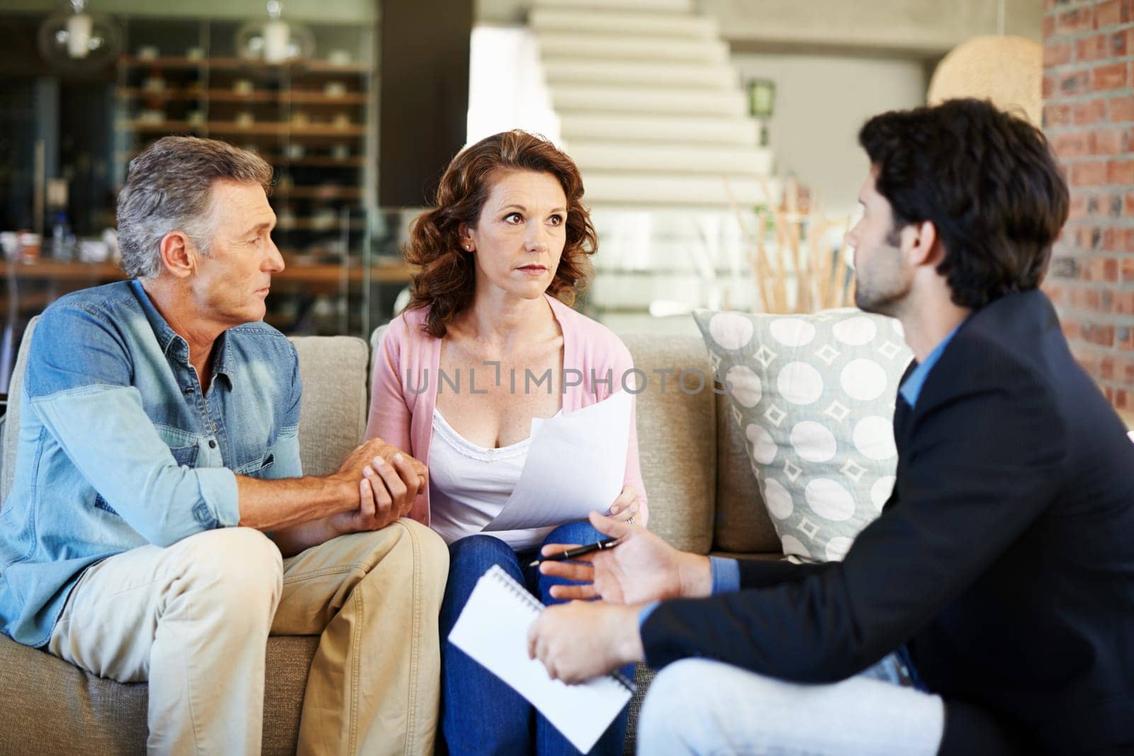 Mature couple, worried and lawyer with documents for mortgage for debt for planning, finances and advice. Man, woman and consultant for pension, offer or agreement in lounge with advisor in home by YuriArcurs