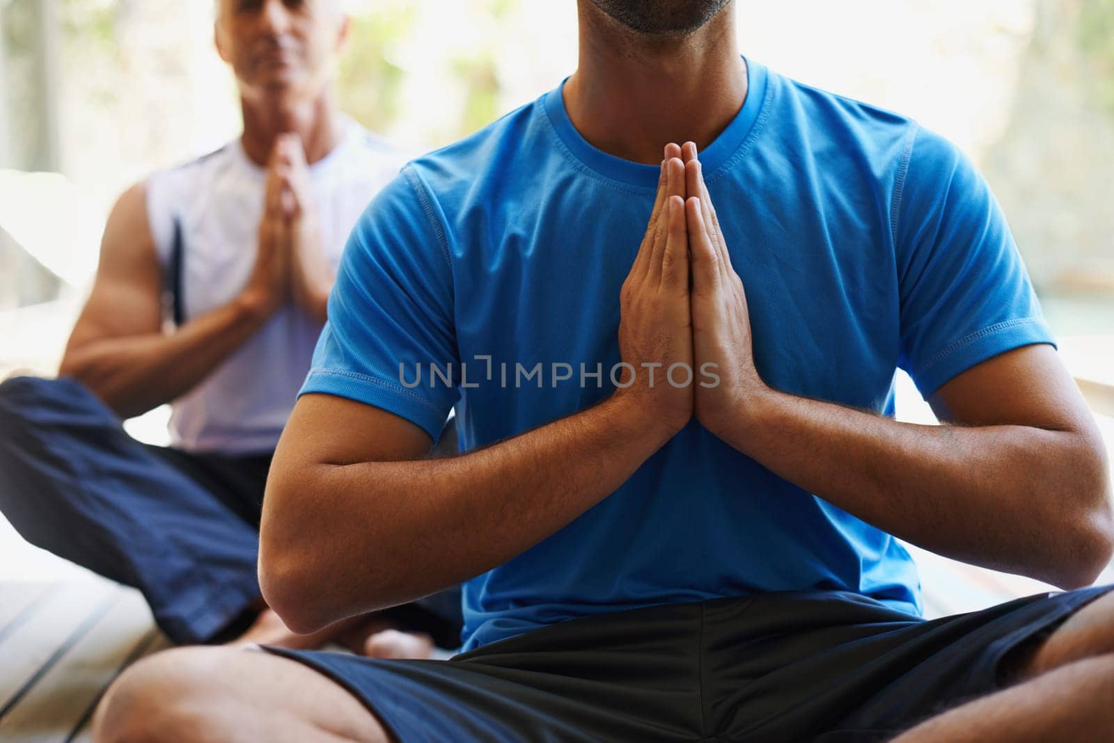 Man, group and yoga class for workout, fitness and wellness for health and meditation. People, sitting and zen for peace, lotus pose and balance with instructor for holistic energy with home pilates.