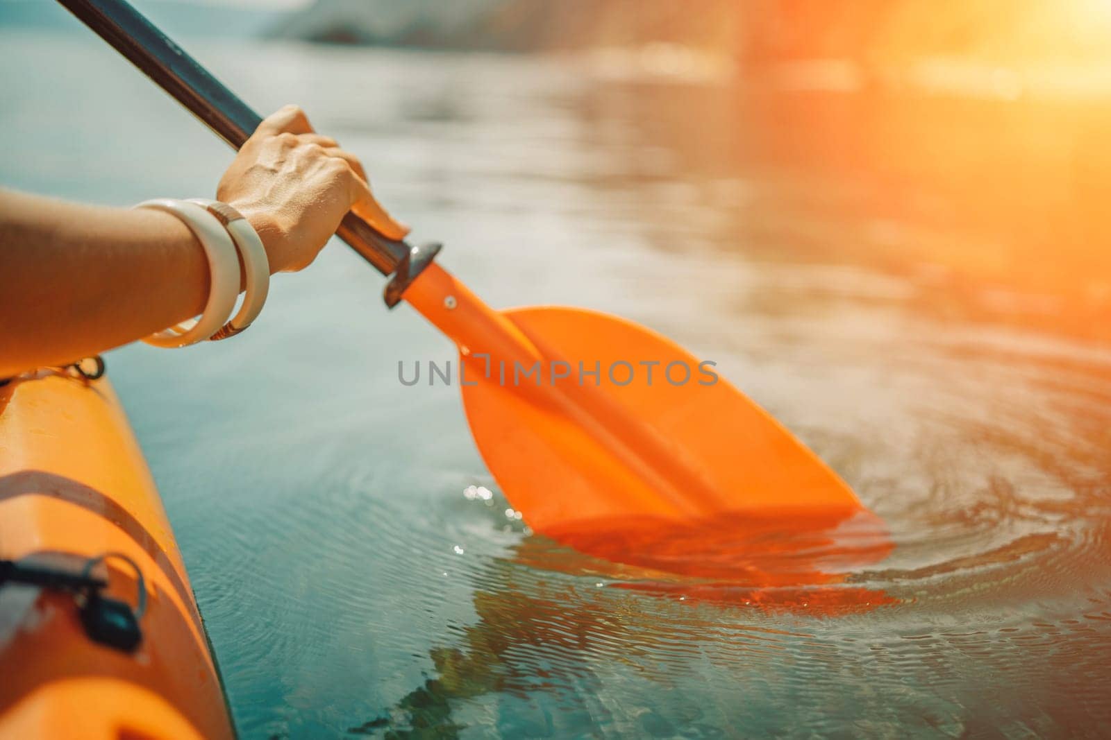 Kayak paddle sea vacation. Person paddles with orange paddle oar on kayak in sea. Leisure active lifestyle recreation activity rest tourism travel.