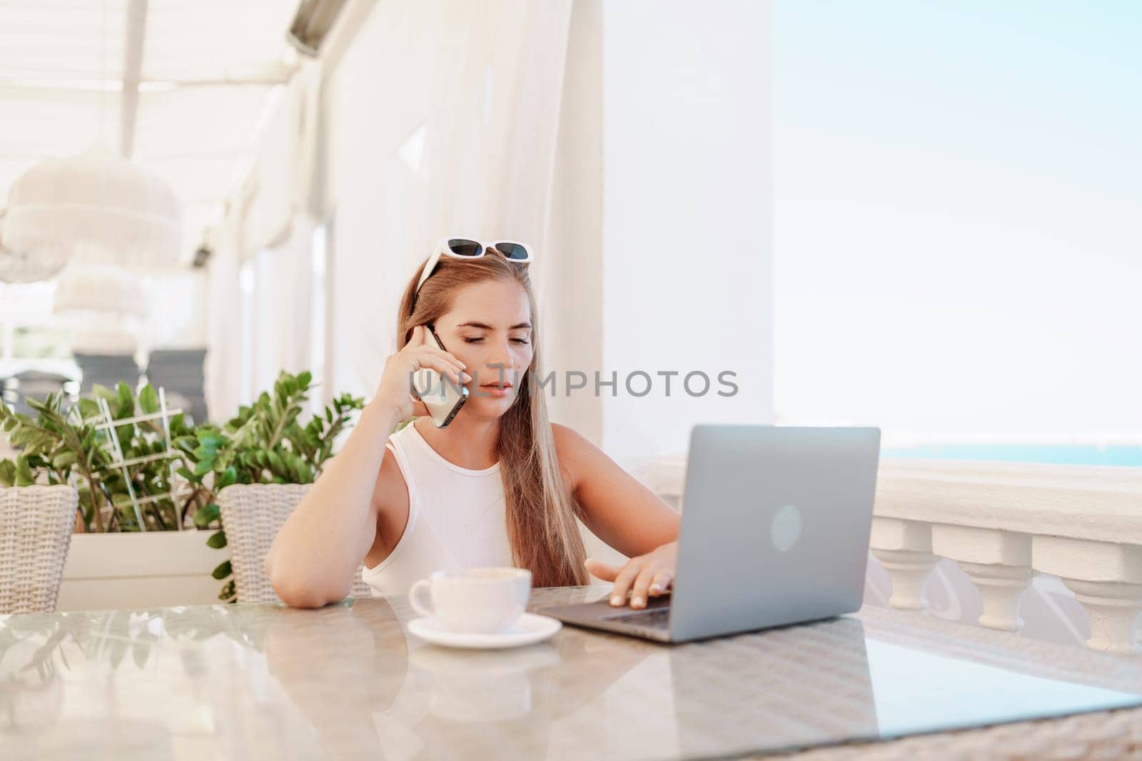 Woman coffee cafe macbook. Woman sitting at a coffee shop with mobile phone drinking coffee and looking away. Caucasian female relaxing at a cafe. by Matiunina