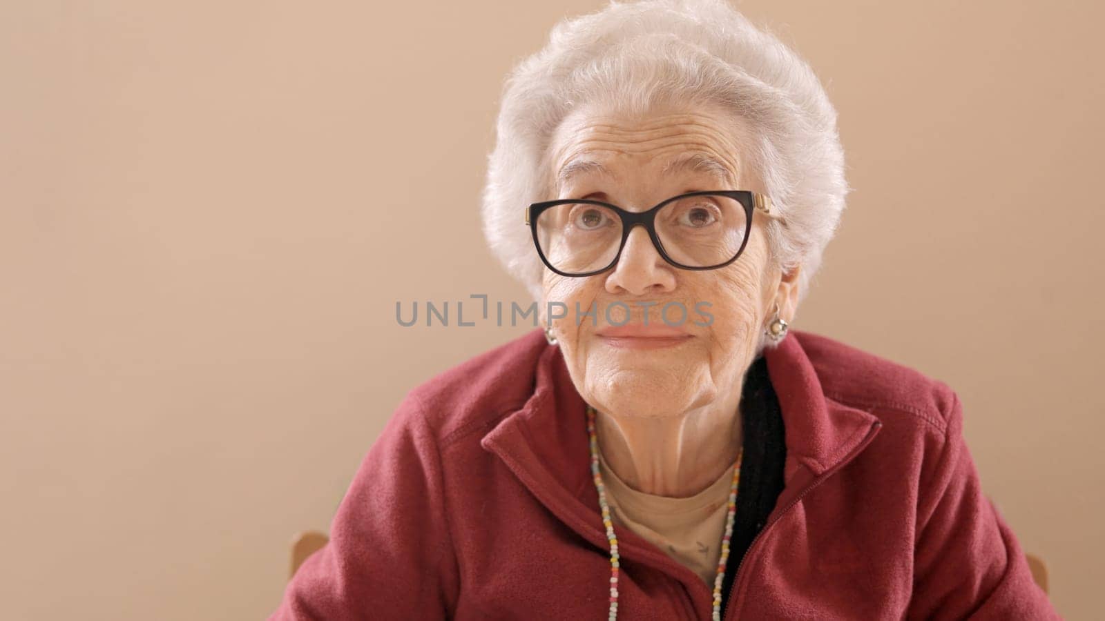 Senior woman with spectacles looking at camera in a geriatric