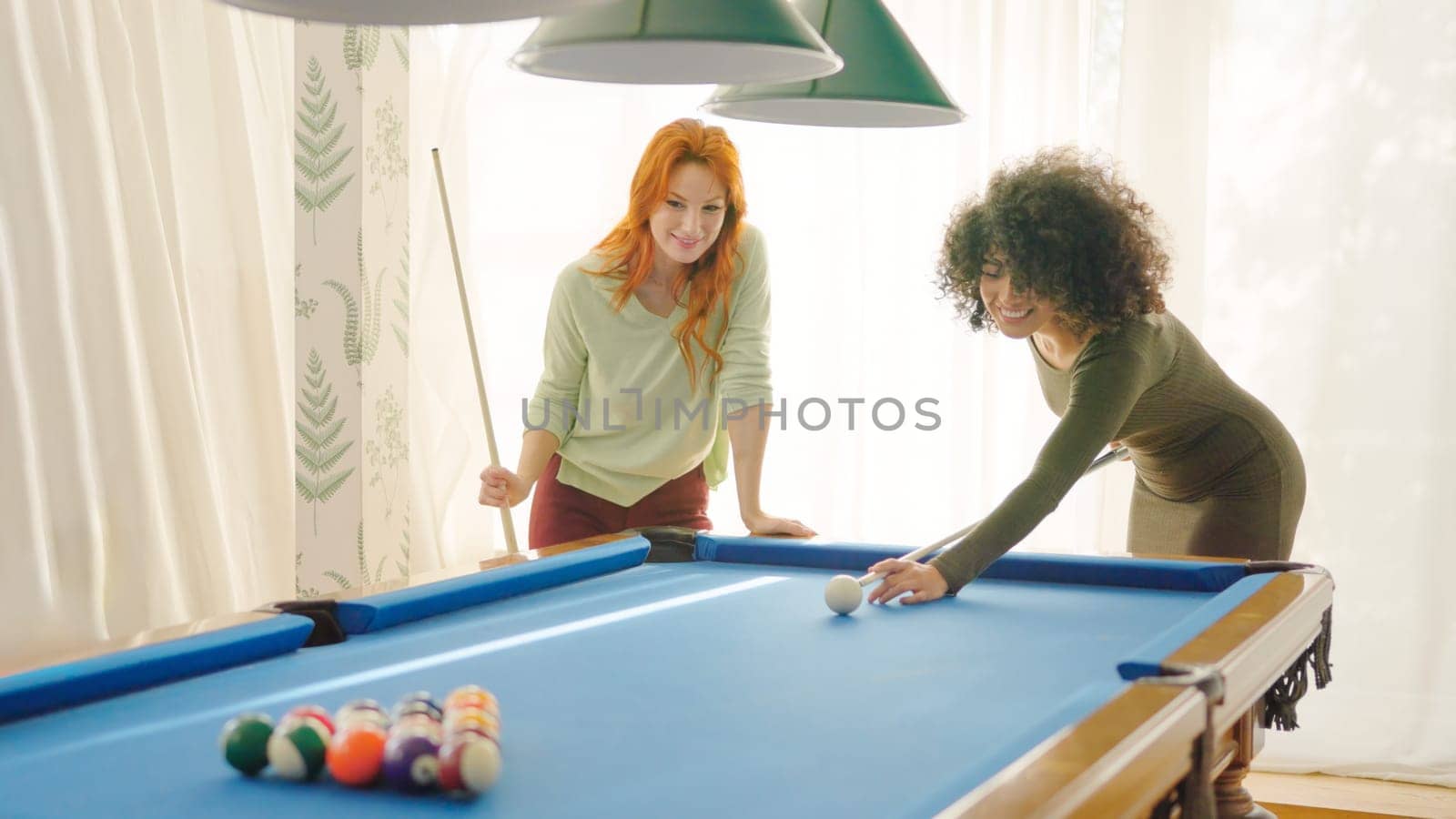 Women starting to play pool at home by ivanmoreno